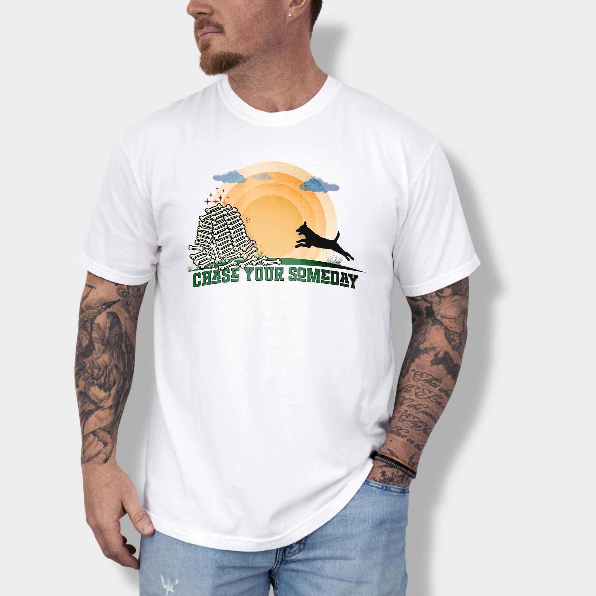Inspirational dog T-shirt featuring a running pup chasing the sun toward a pile of bones with 'Chase Your Someday' text