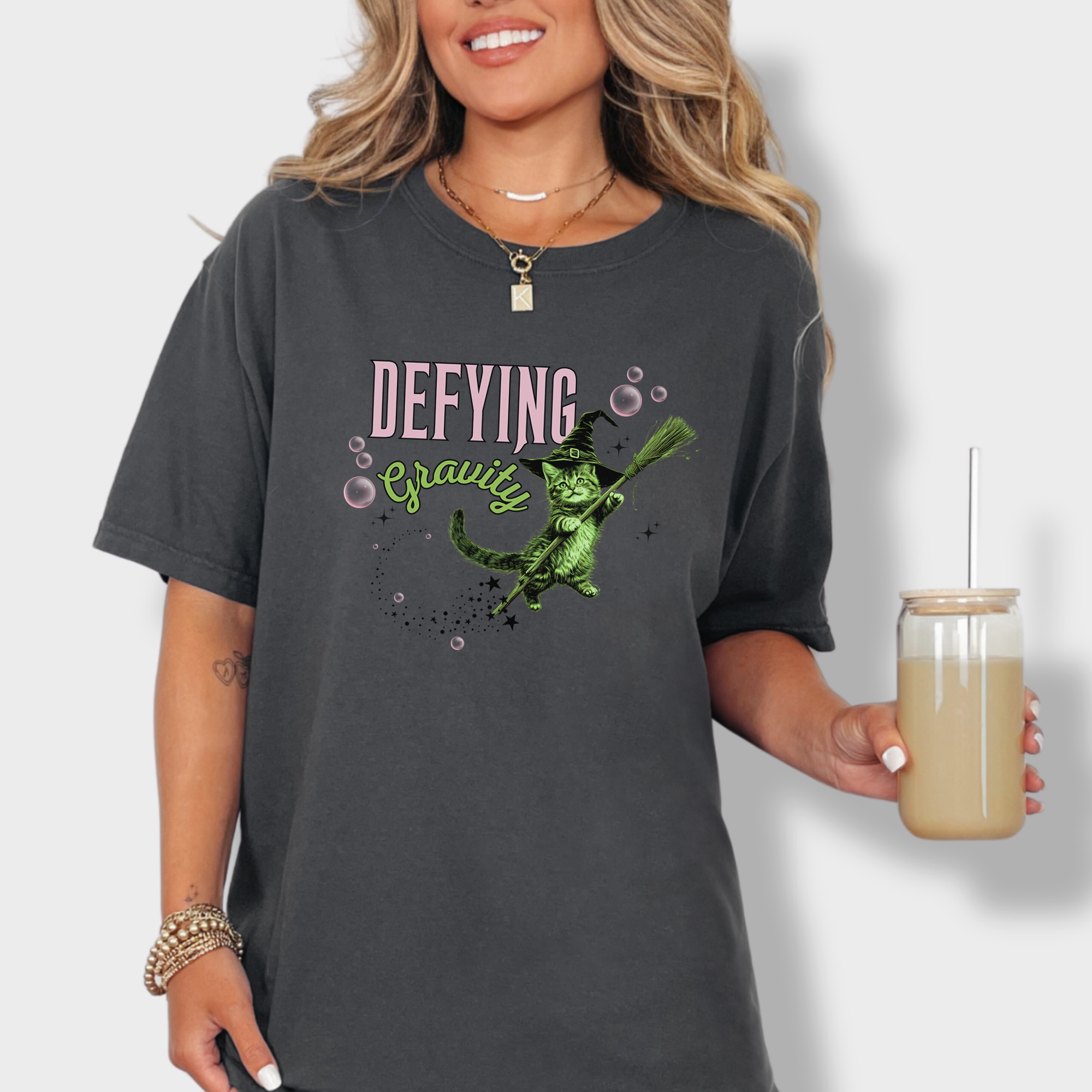 Adorable Wicked-inspired green cat witch design on a breathable 100% cotton T-shirt. A must-have for cat lovers