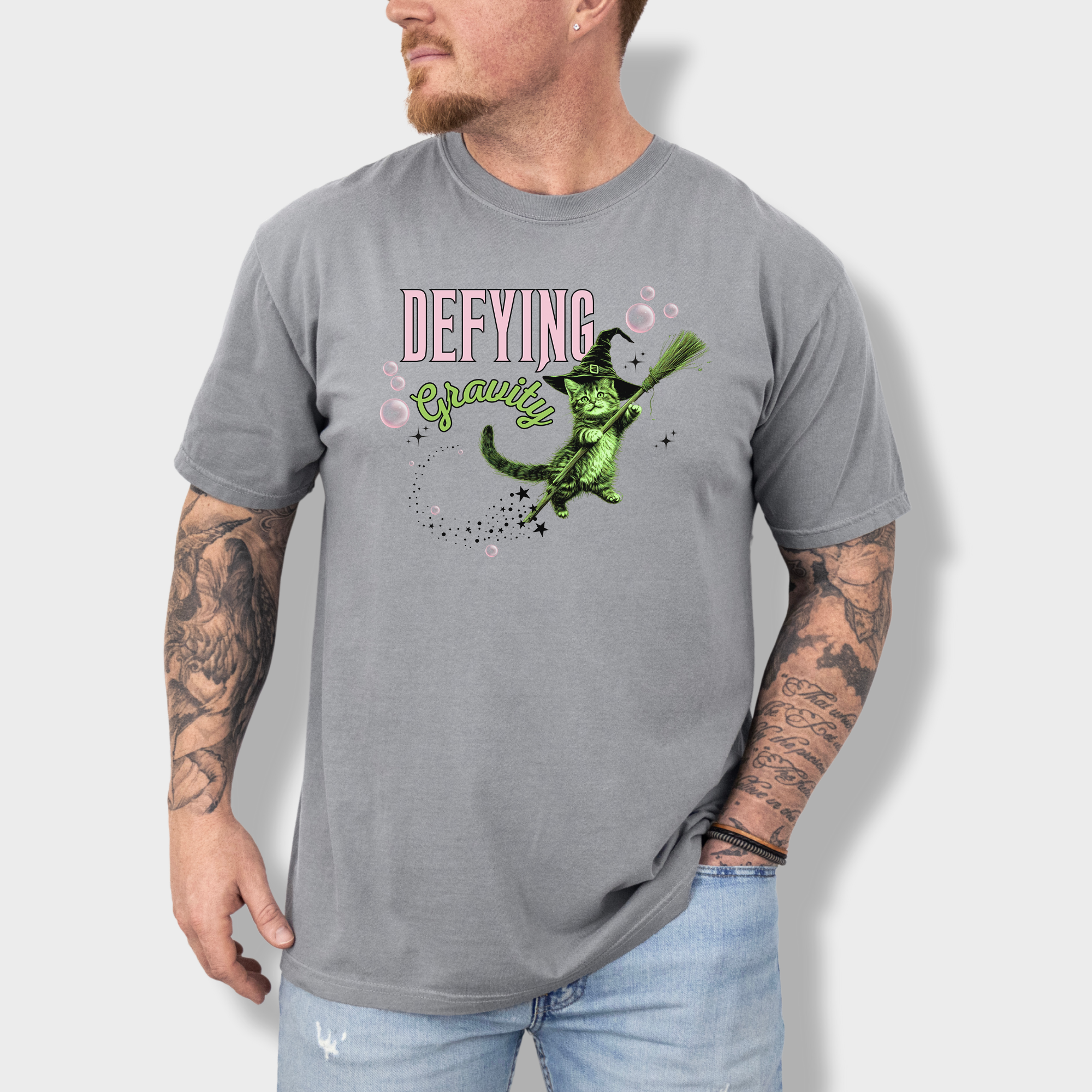 One-of-a-kind retro cat T-shirt with a magical levitating green witch cat print. Perfect for feline fans and fantasy lovers.