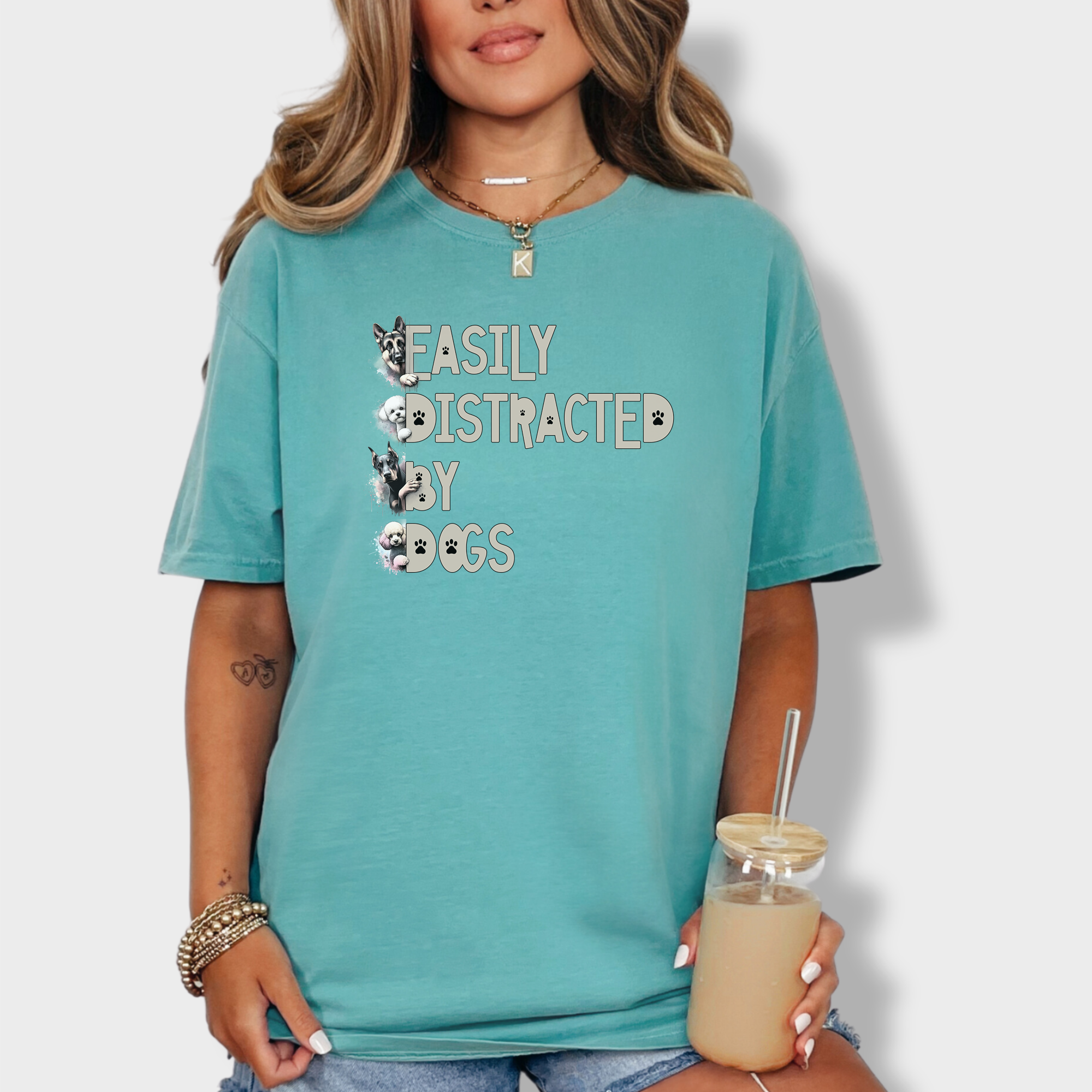 Funny pet lover’s tee with a vibrant design, featuring playful dog breeds surrounding the text 'Easily Distracted by Dogs'.