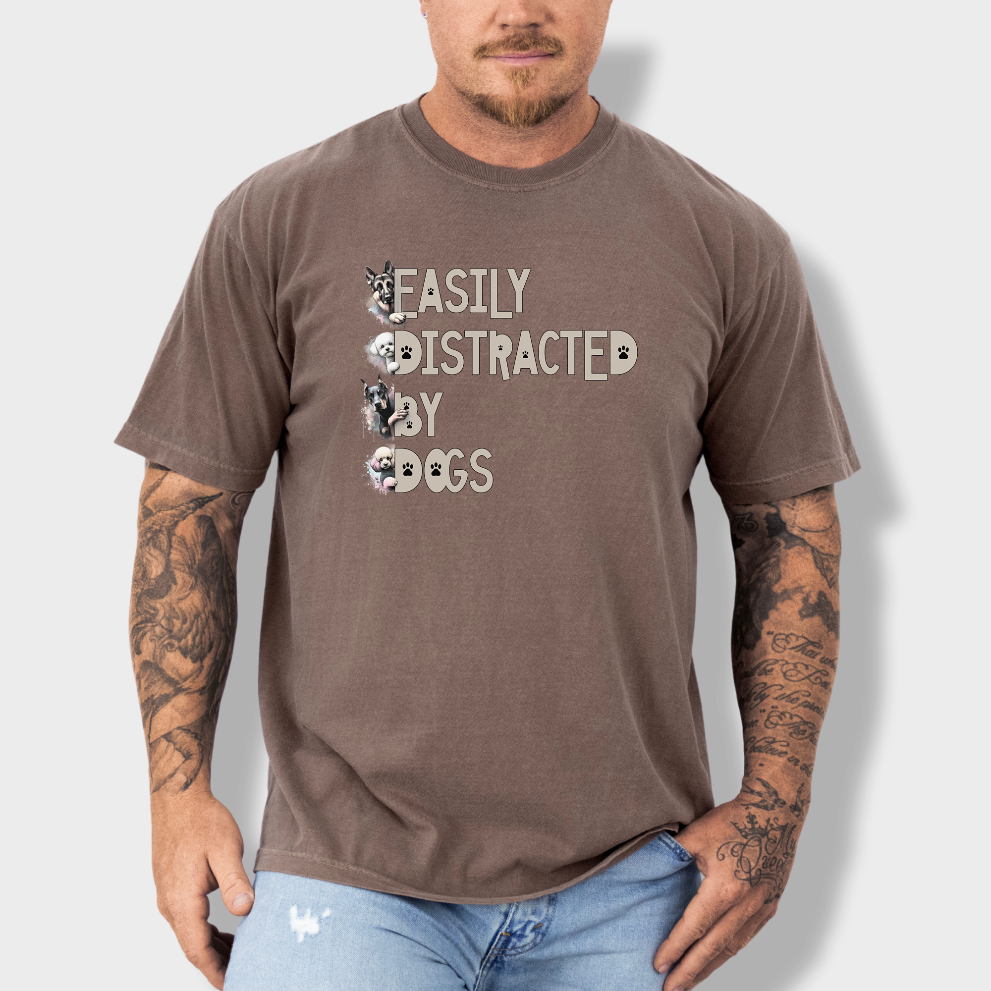 Colorful watercolor dog T-shirt featuring the phrase 'Easily Distracted by Dogs' with illustrations of a German Shepherd, Bichon Frise, Doberman, and Miniature Poodle.