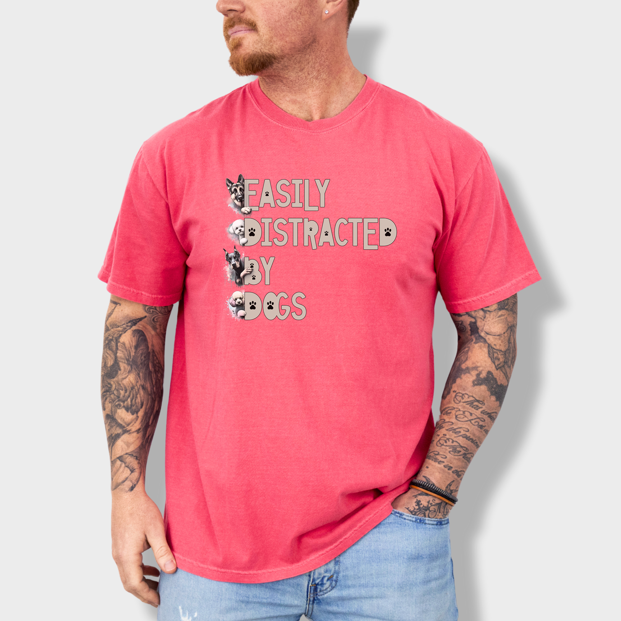 Colorful watercolor dog T-shirt featuring the phrase 'Easily Distracted by Dogs' with illustrations of a German Shepherd, Bichon Frise, Doberman, and Miniature Poodle.