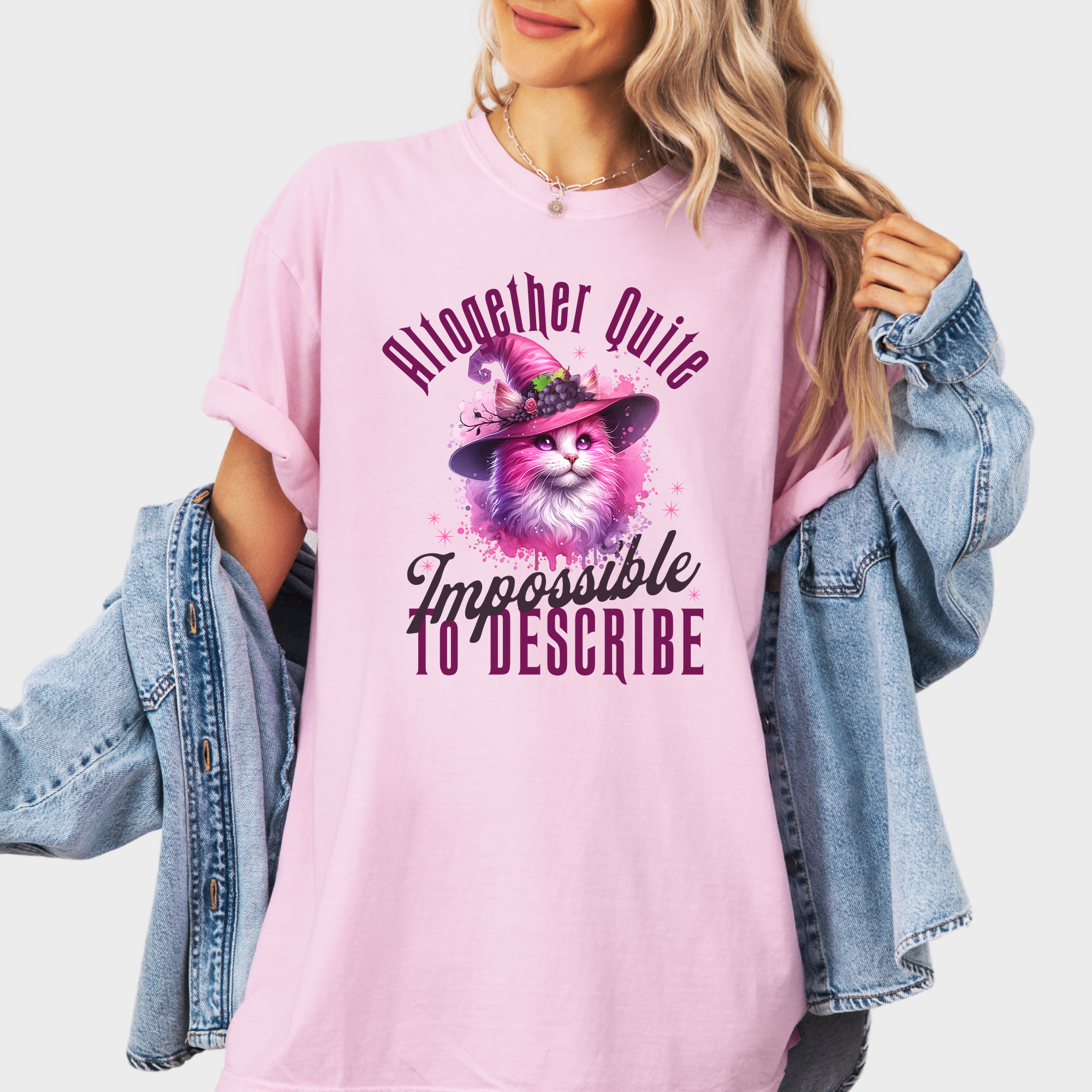 Magical pink cat T-shirt with a watercolor witch-themed design and a quote nodding to the iconic Wicked musical.