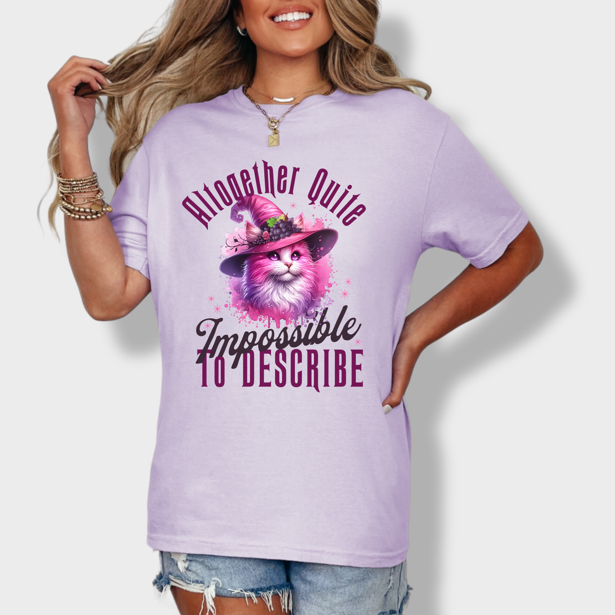 Charming artistic T-shirt featuring a pink witch cat in watercolor style, paired with the phrase 'altogether quite impossible to describe.