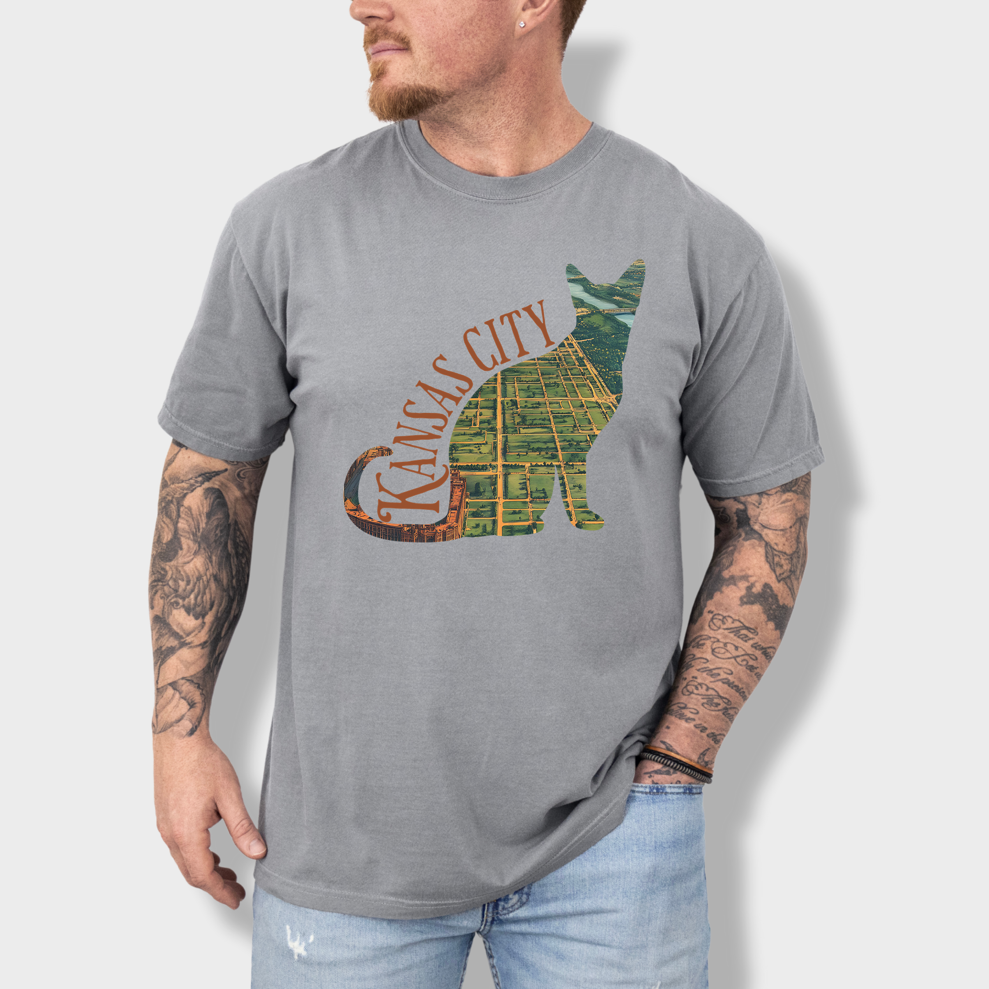 Artistic Kansas City-themed T-shirt with a satellite map of Missouri’s largest city bordered by a cat outline, perfect for cat lovers and city dwellers.