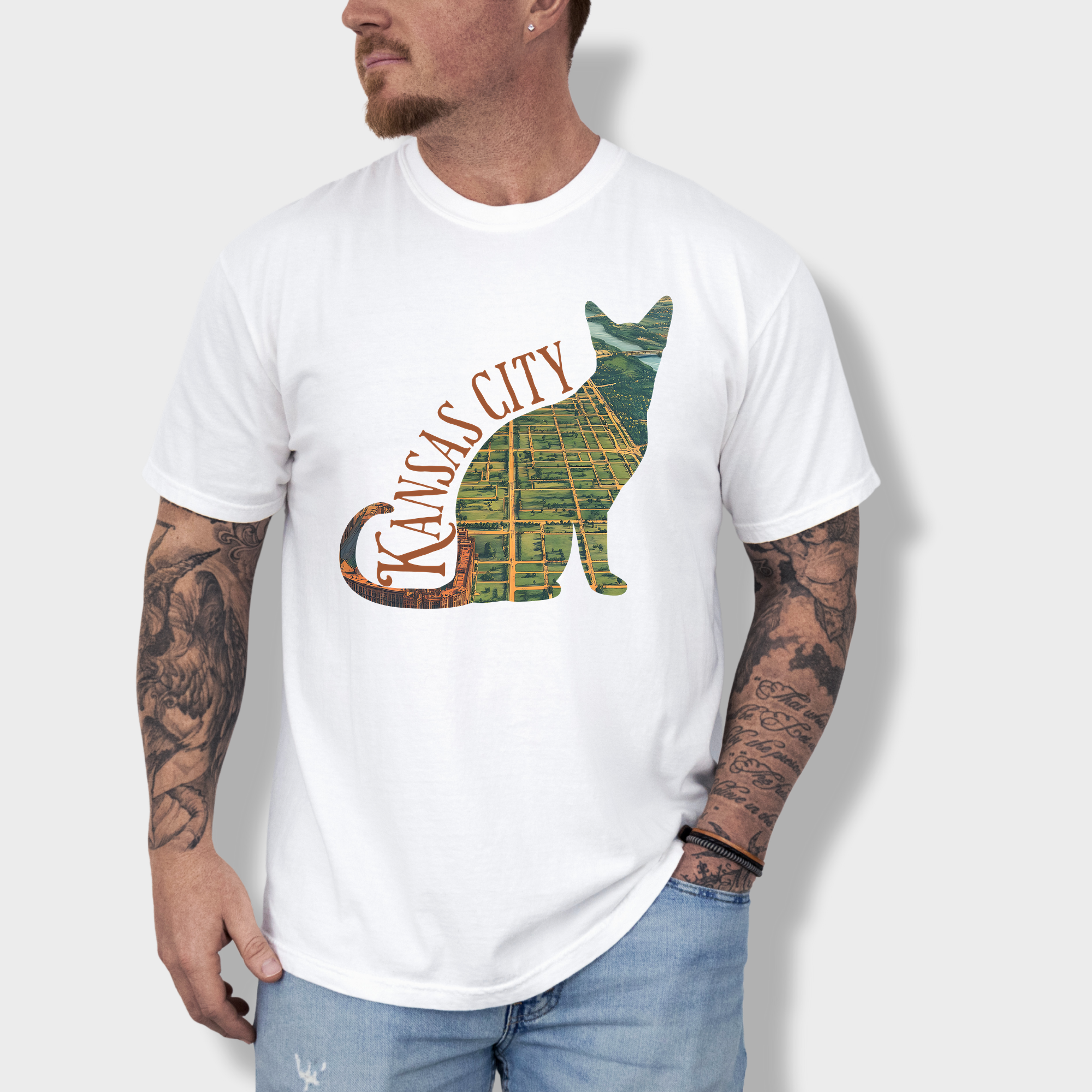 Artistic Kansas City-themed T-shirt with a satellite map of Missouri’s largest city bordered by a cat outline, perfect for cat lovers and city dwellers.