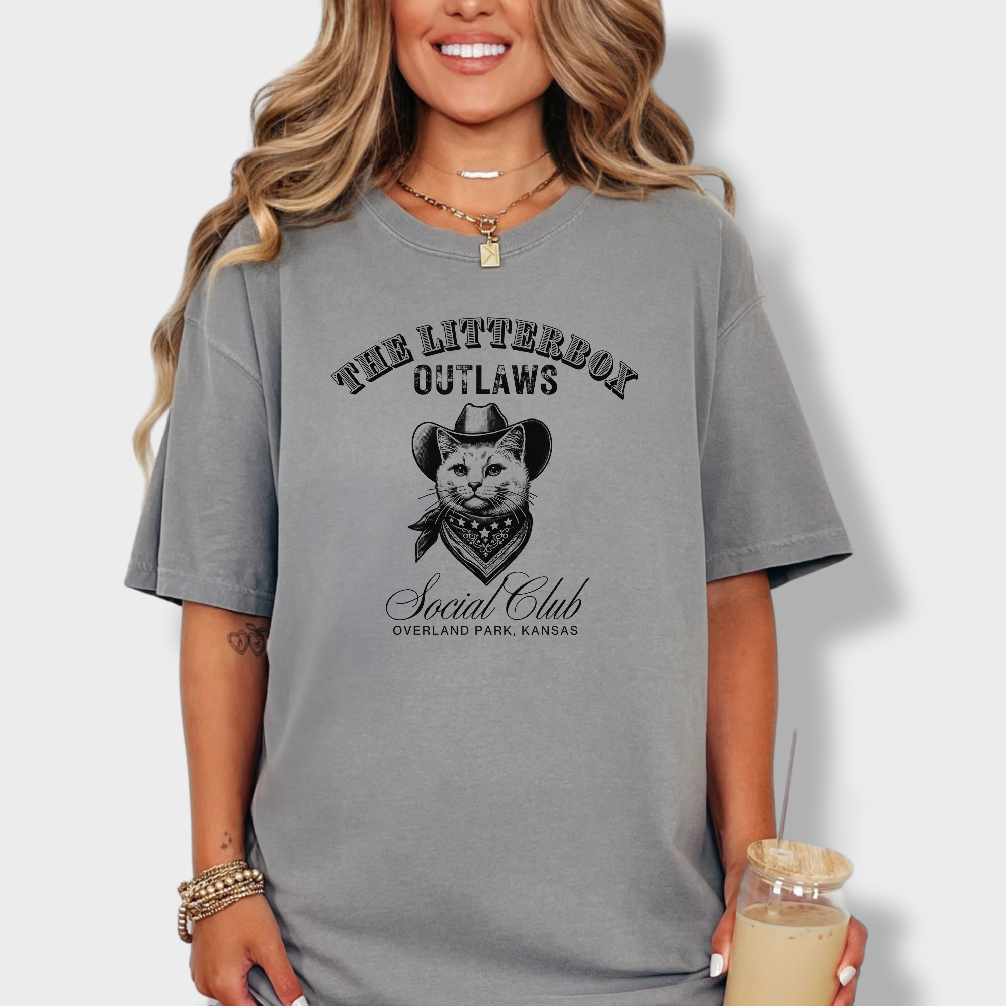 Western-style cat T-shirt featuring a line-art cat in a cowboy hat with 'Litterbox Outlaws Social Club' text, customizable with city and state.