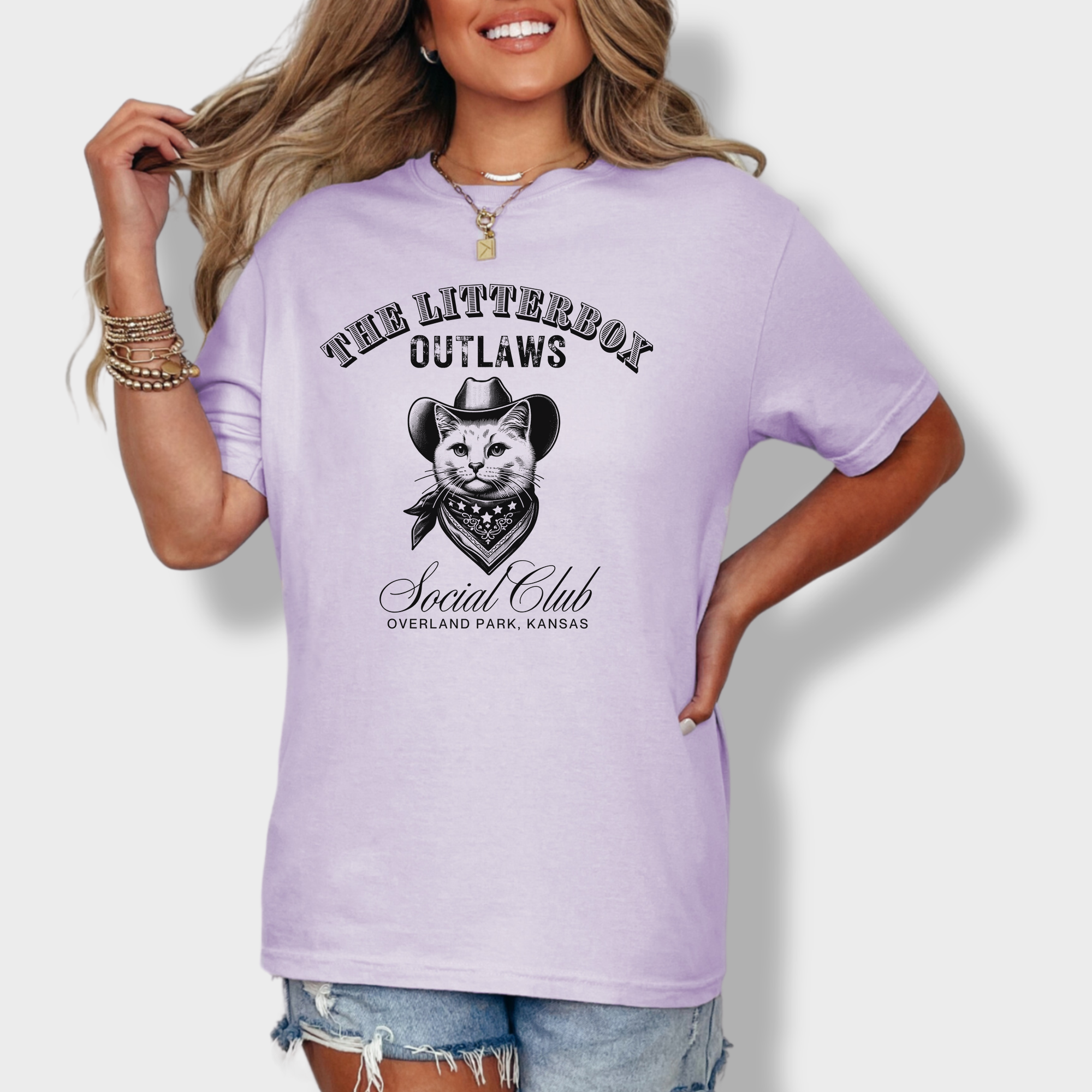 Soft cotton T-shirt featuring a rugged outlaw cat in a cowboy hat, part of the Litterbox Outlaws Social Club, with a personalized location.