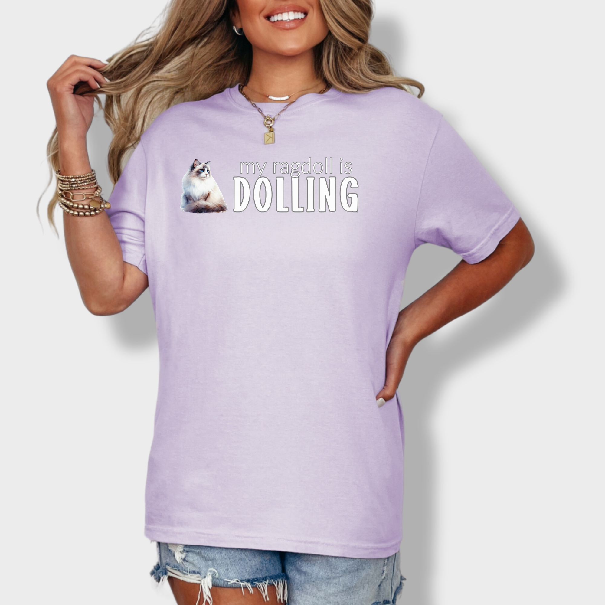 Minimalist watercolor-style Ragdoll cat tee with 'My Ragdoll is Dolling' text, perfect for Ragdoll cat owners