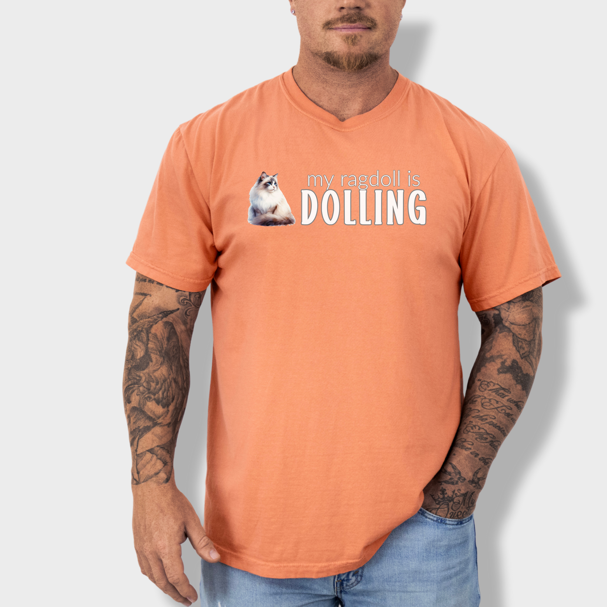 Retro-inspired Ragdoll cat T-shirt with a unique watercolor print and the phrase 'My Ragdoll is Dolling' in stylish lettering.