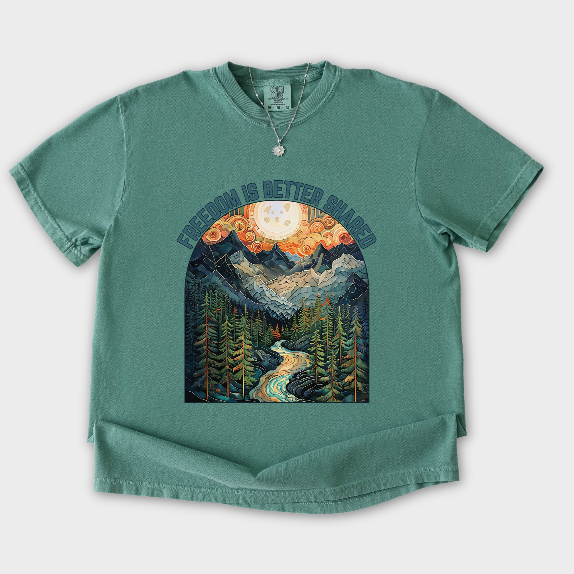 artistic-mountain-freedom-is-better-shared-stained-glass-version-dog-graphic-comfort-colors-t-shirt-in-light-green - Light Green Flat Lay Front