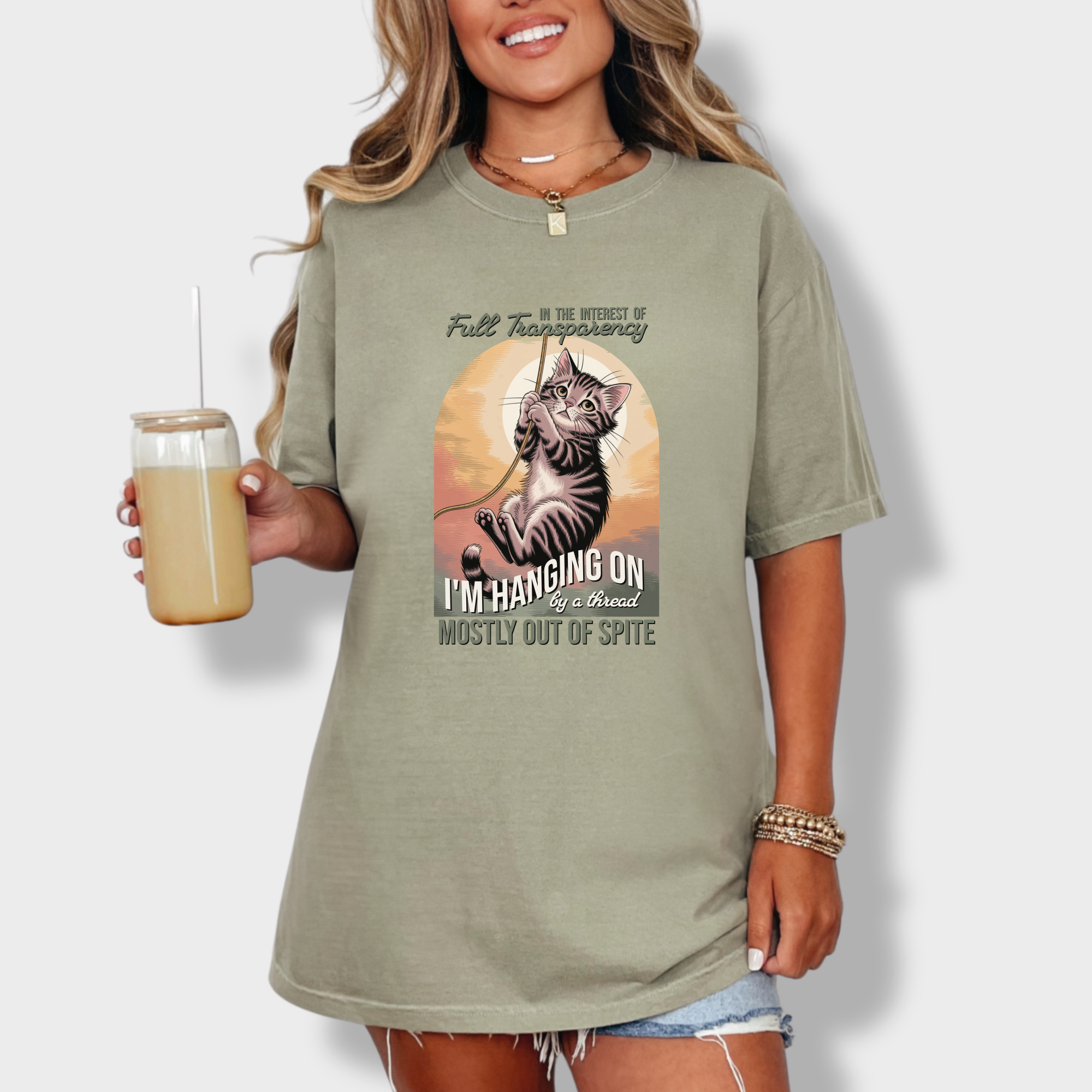 western-hanging-on-by-a-thread-cat-graphic-comfort-colors-t-shirt-in-khaki - Khaki Lifestyle Female Model
