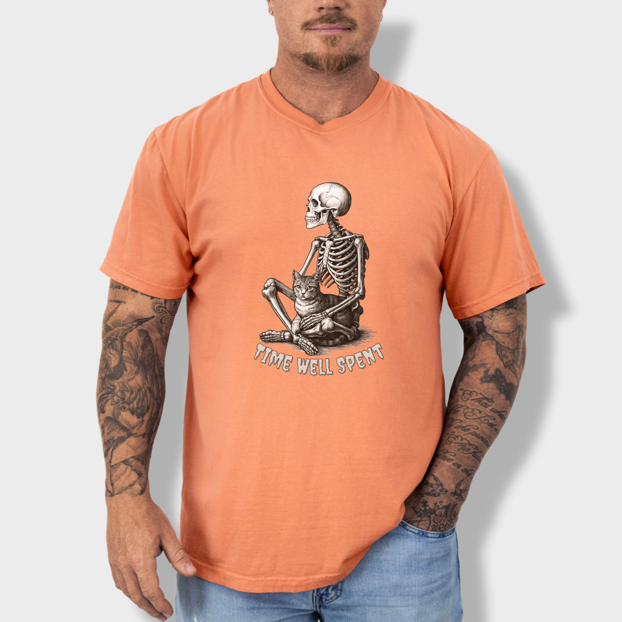 line-art-sit-still-skeleton-petting-cat-cat-skeleton-comfort-colors-t-shirt-in-terracotta - Terracotta Lifestyle Male Model