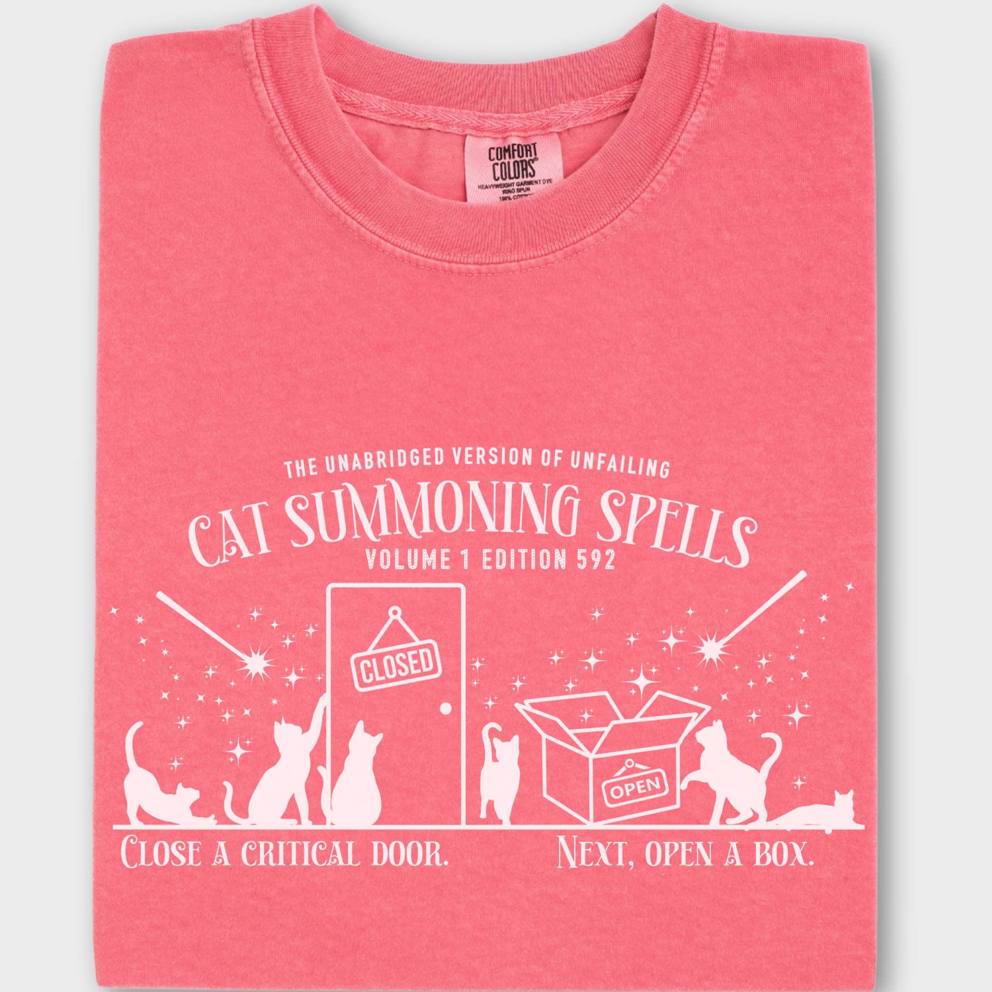 Unique retro-style cat T-shirt with a mystical spellbook graphic, humorously showing how cats magically appear at doors and boxes.