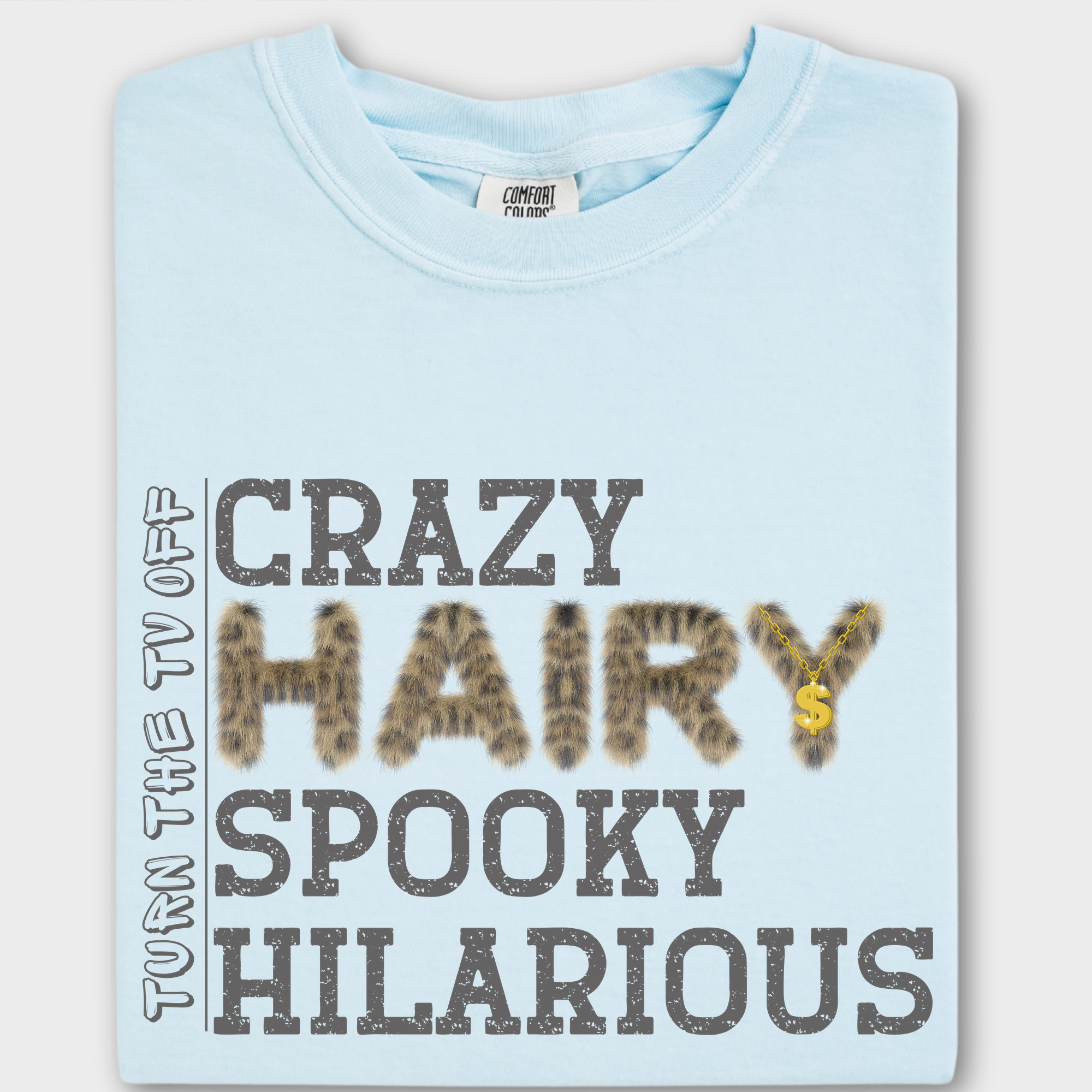 Funny hip-hop inspired T-shirt featuring the phrase 'Crazy Hairy Spooky Hilarious' in a fur-textured font with a gold chain detail.