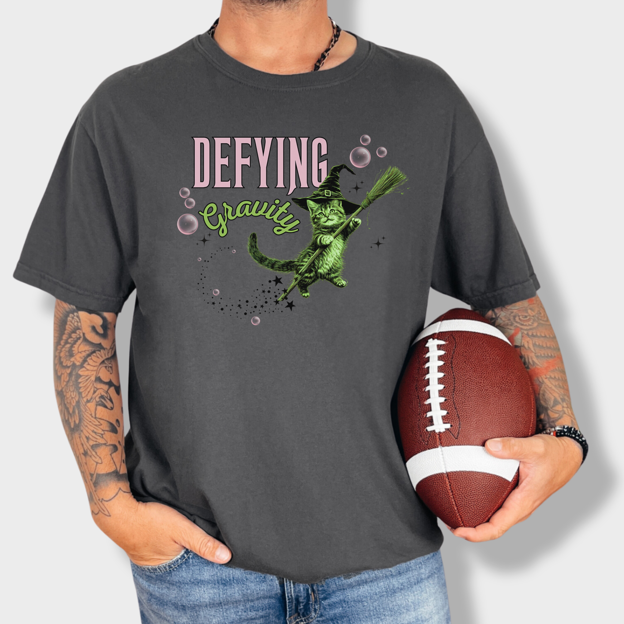 One-of-a-kind retro cat T-shirt with a magical levitating green witch cat print. Perfect for feline fans and fantasy lovers.