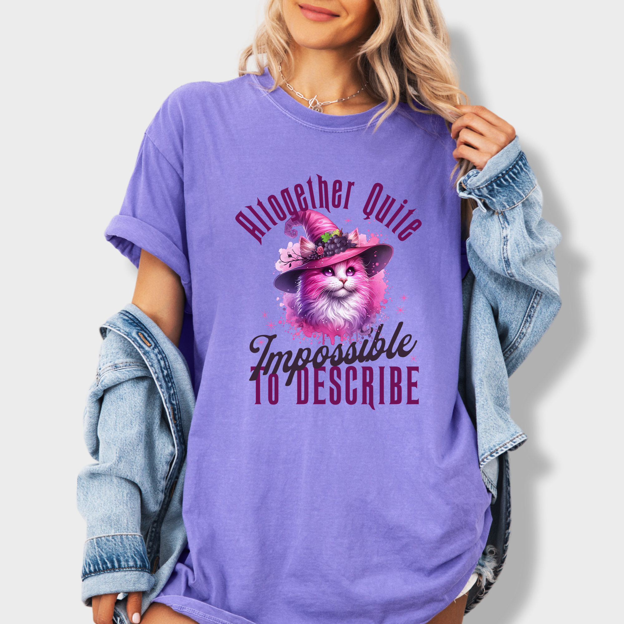 Magical pink cat T-shirt with a watercolor witch-themed design and a quote nodding to the iconic Wicked musical.