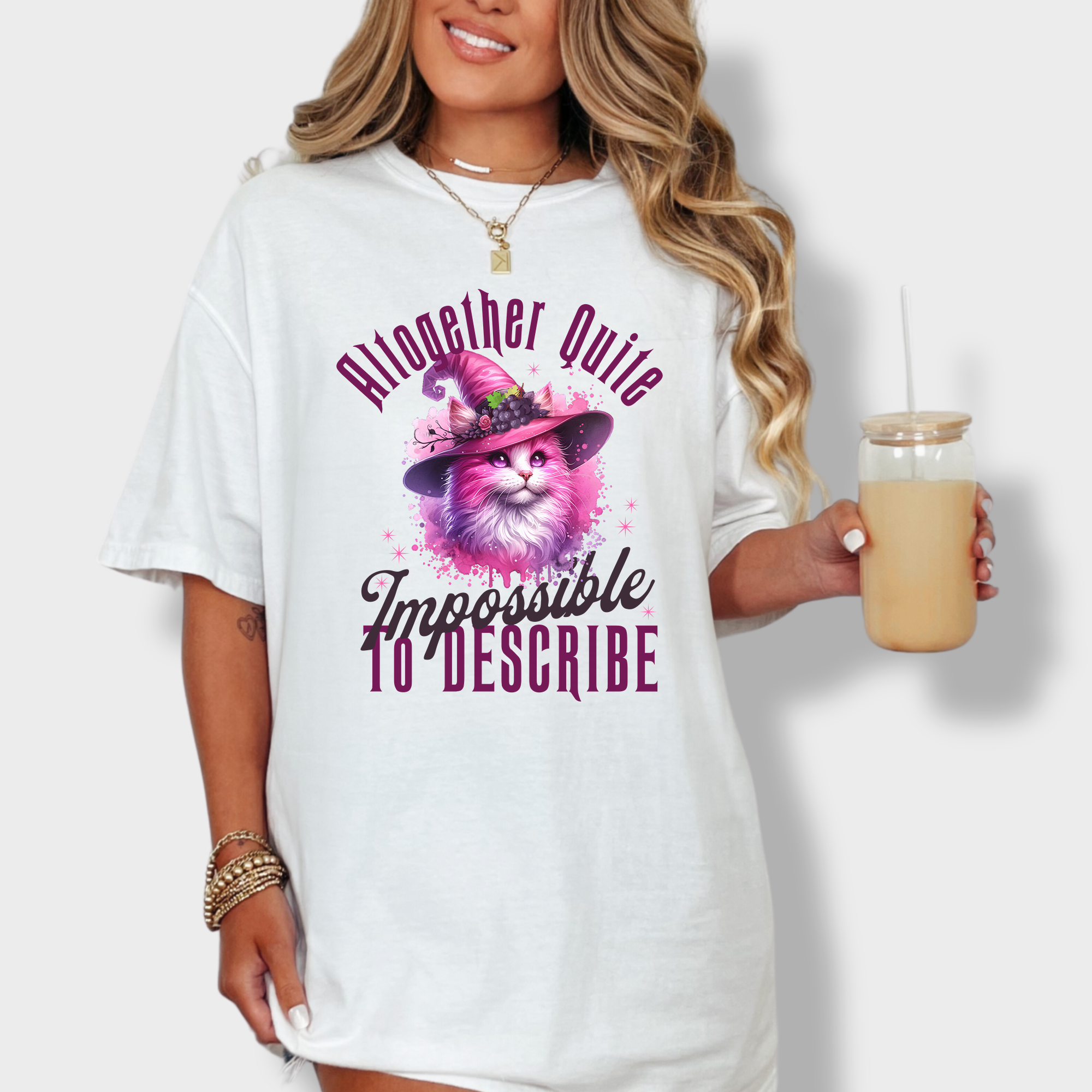 Charming artistic T-shirt featuring a pink witch cat in watercolor style, paired with the phrase 'altogether quite impossible to describe.