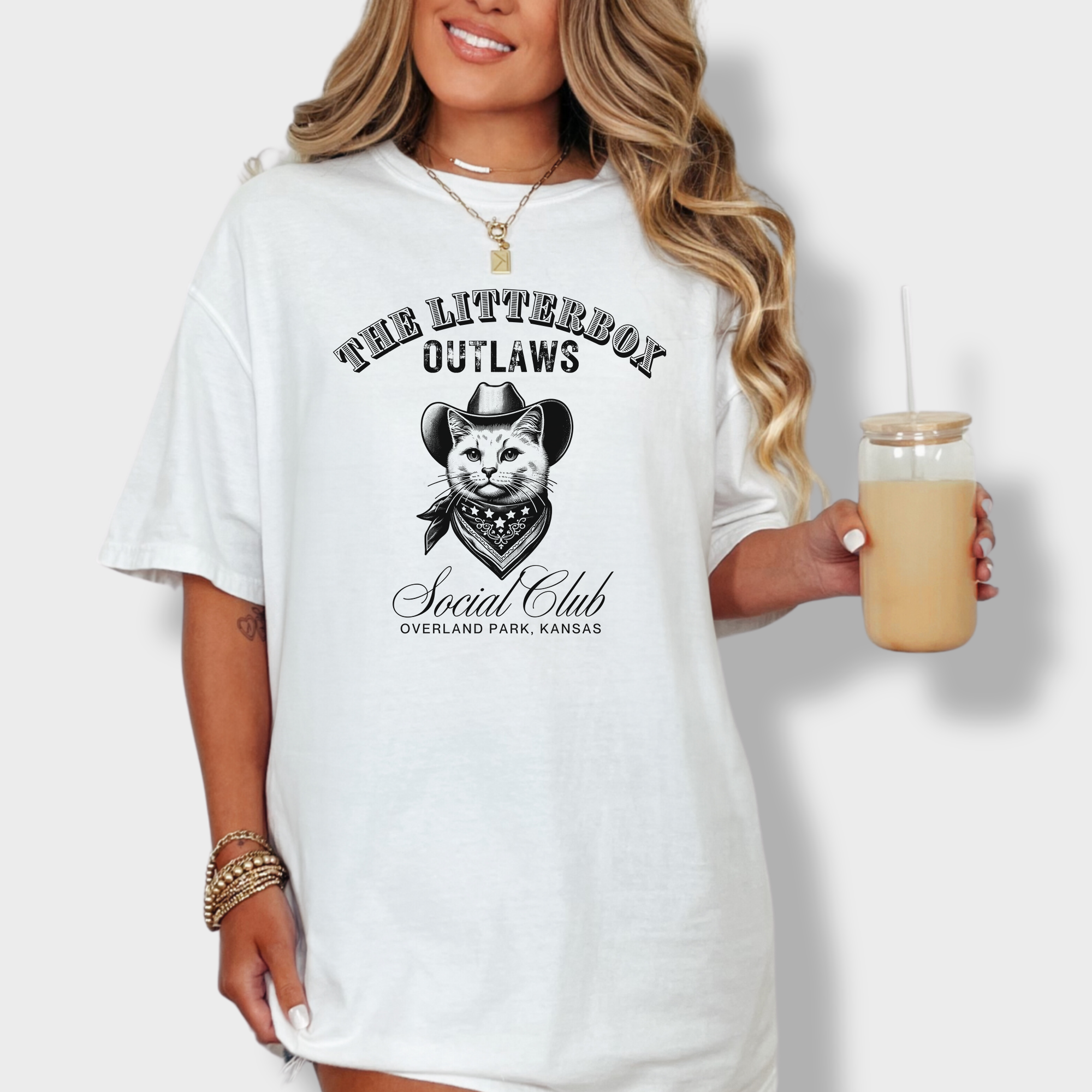 Western-style cat T-shirt featuring a line-art cat in a cowboy hat with 'Litterbox Outlaws Social Club' text, customizable with city and state.