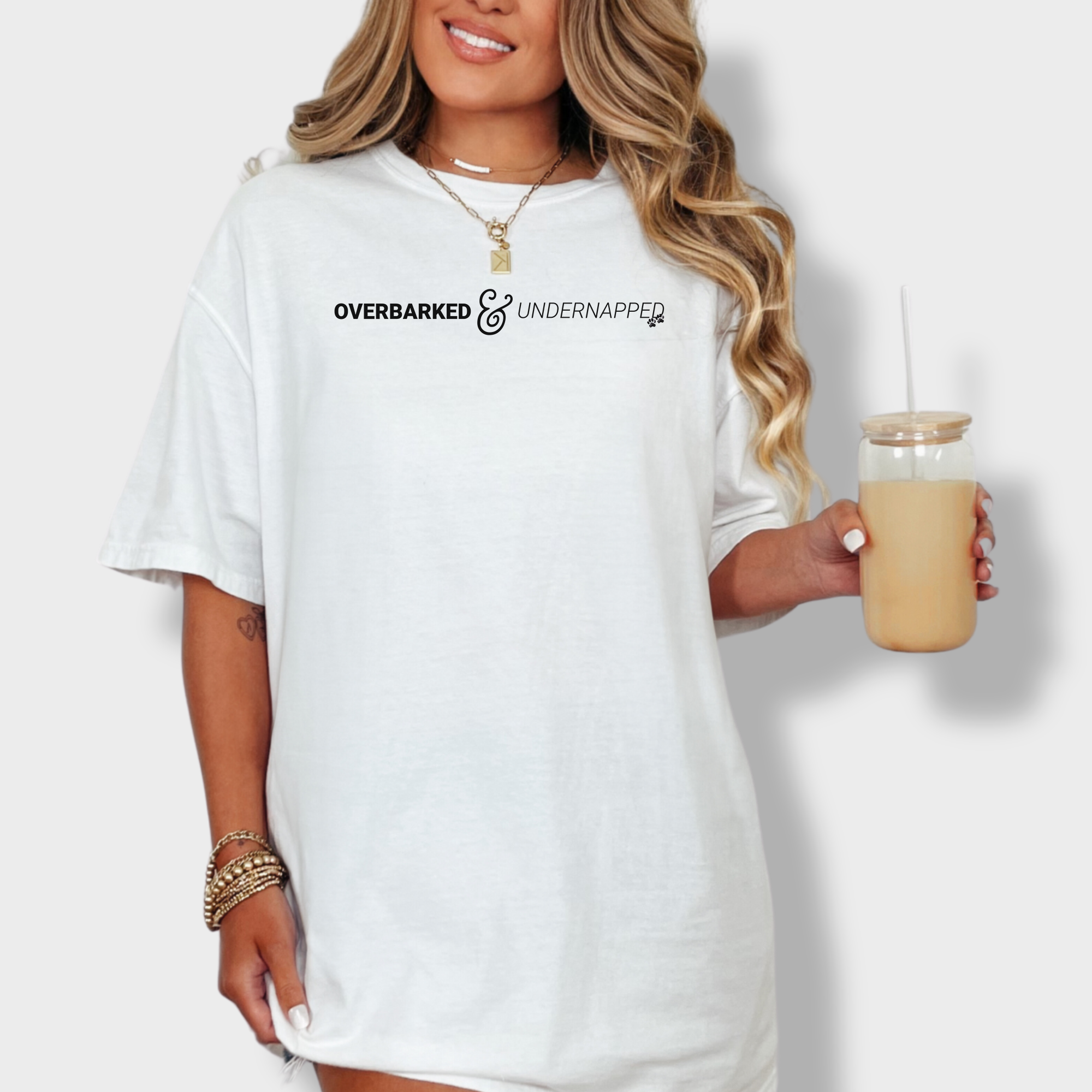 Minimalist pet parent tee with bold text reading 'Overbarked & Undernapped,' perfect for sleep-deprived dog lovers.