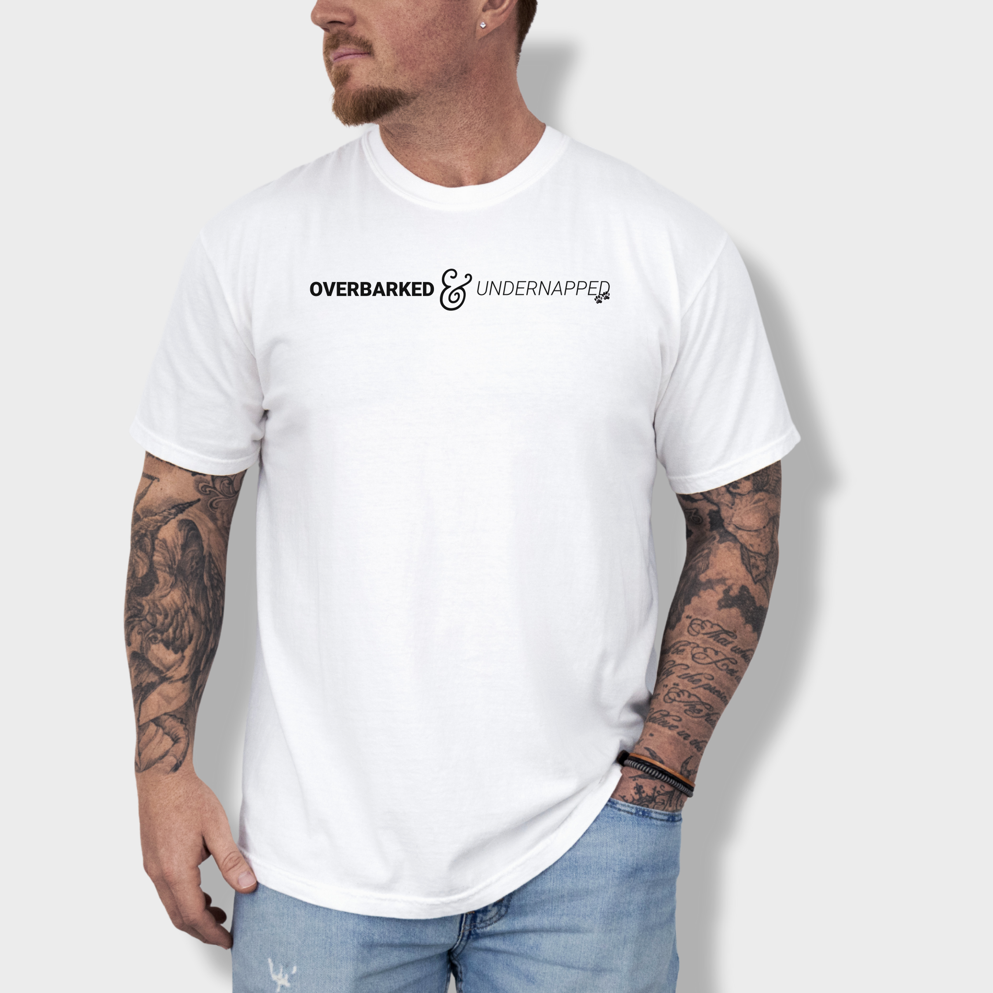 Humorous dog-themed graphic tee featuring a witty phrase about tired pet parents, accented with two paw prints