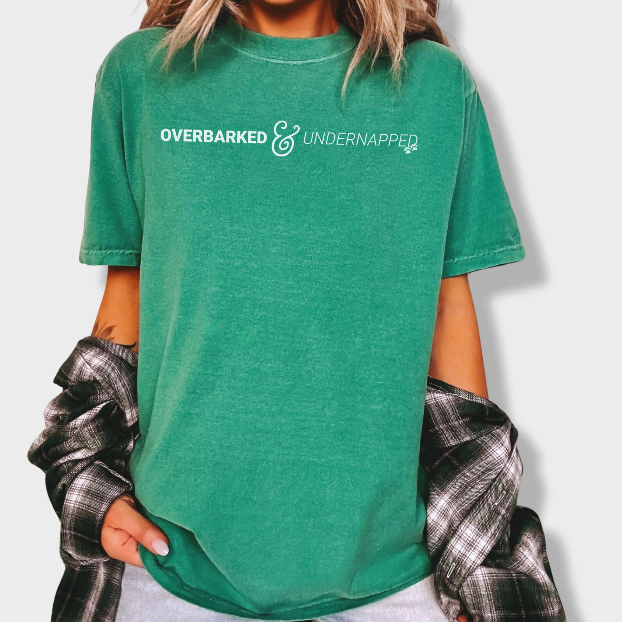 Minimalist pet parent tee with bold text reading 'Overbarked & Undernapped,' perfect for sleep-deprived dog lovers.