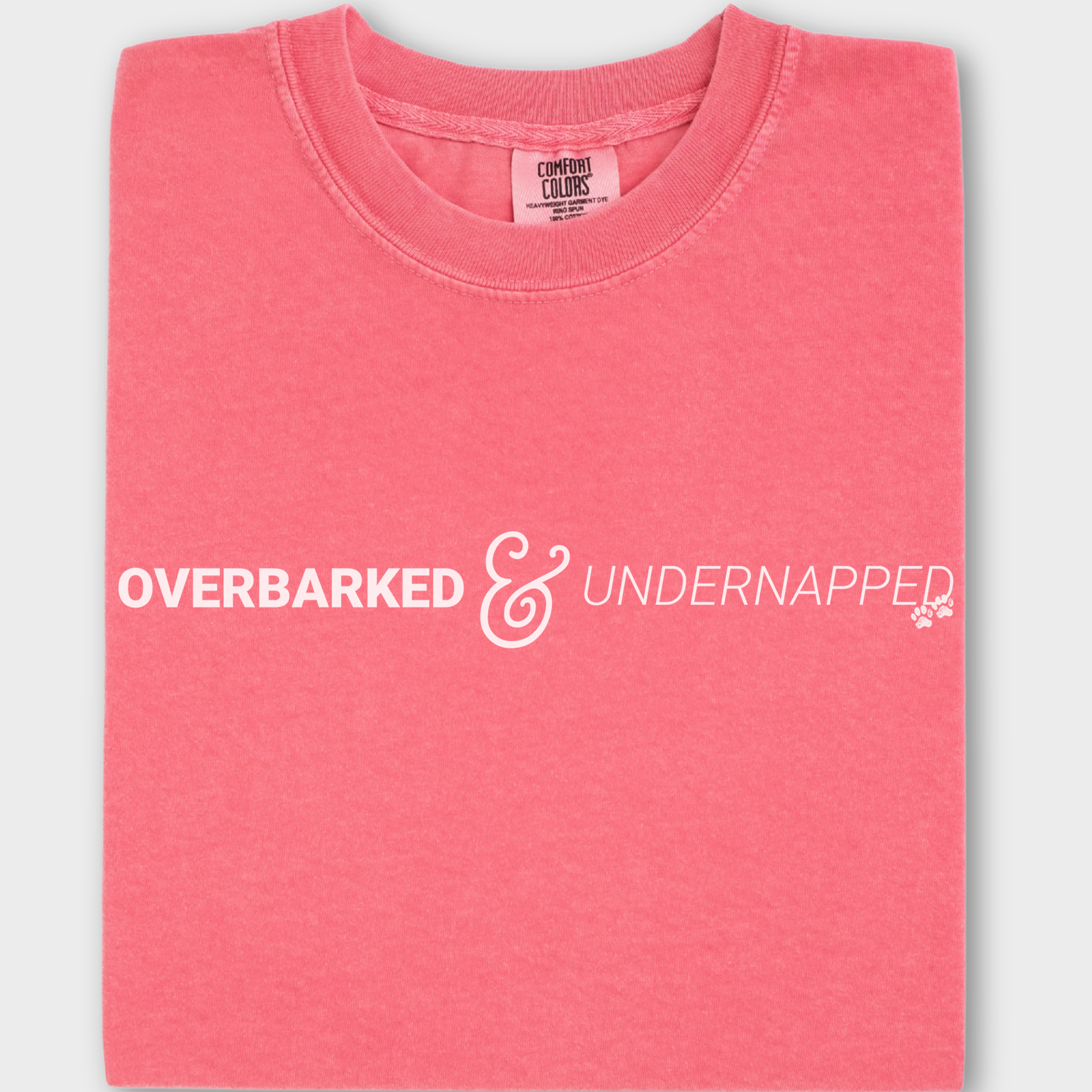 Funny dog lover’s T-shirt featuring the phrase 'Overbarked & Undernapped' with two paw prints, printed on soft cotton.