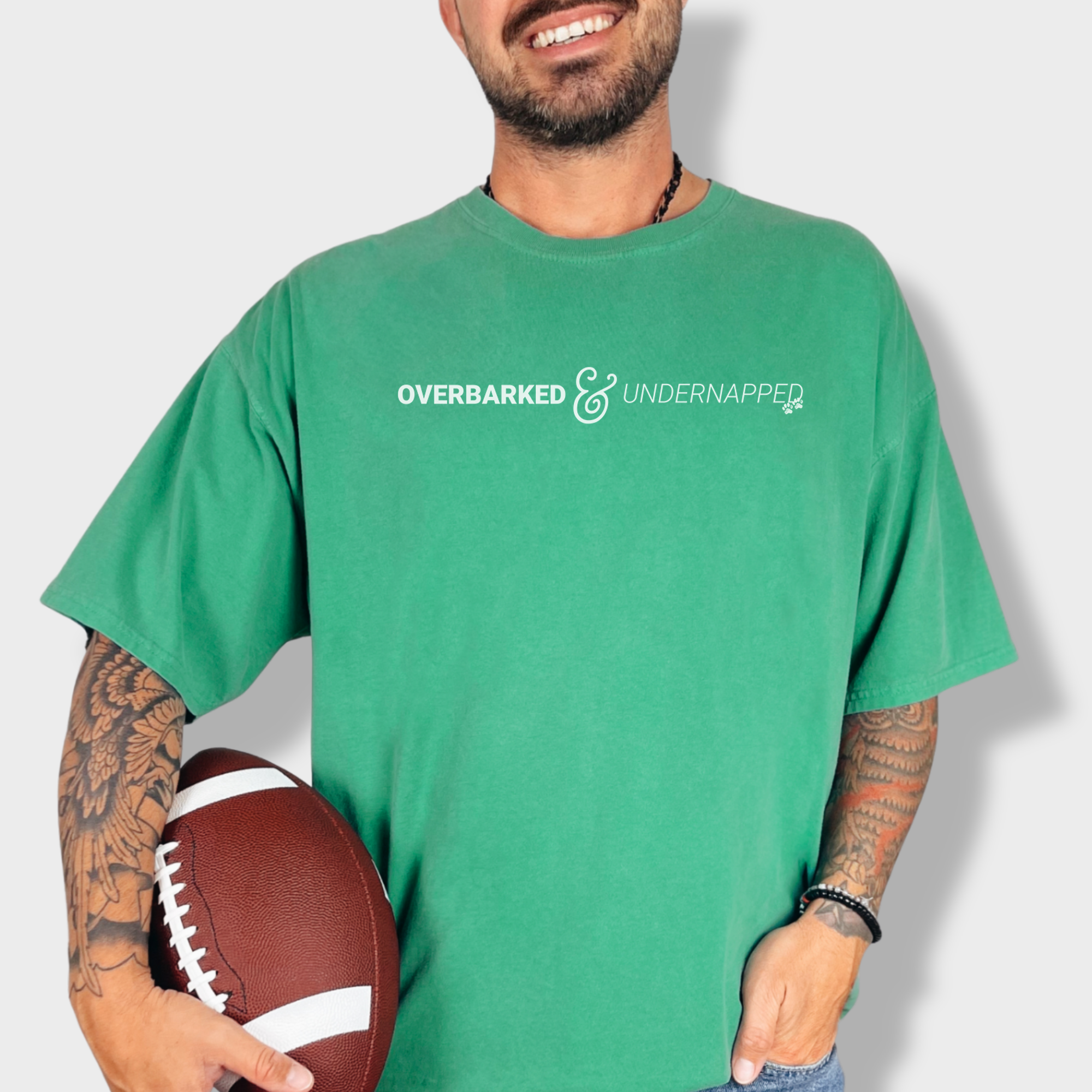 Humorous dog-themed graphic tee featuring a witty phrase about tired pet parents, accented with two paw prints