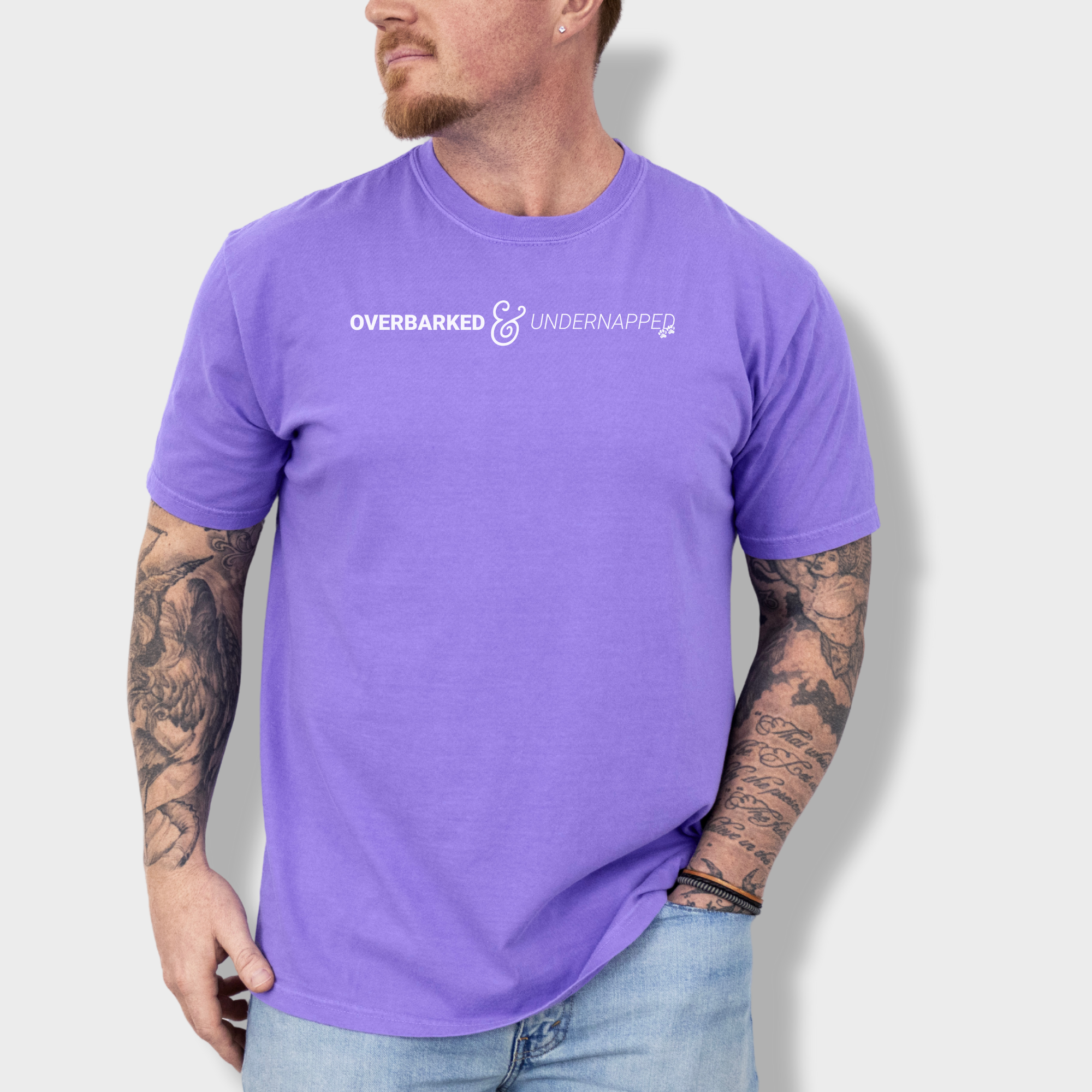 Funny dog lover’s T-shirt featuring the phrase 'Overbarked & Undernapped' with two paw prints, printed on soft cotton.
