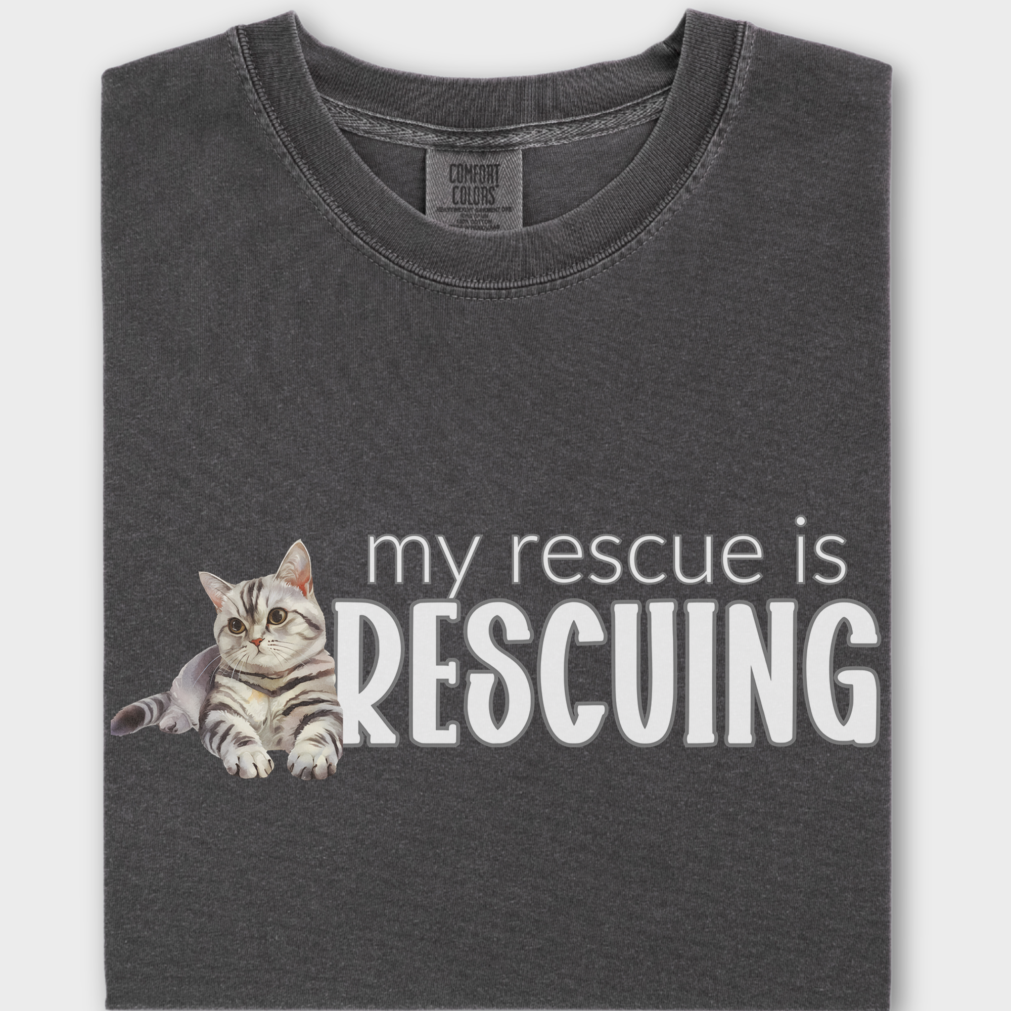 Watercolor rescue cat T-shirt with the heartfelt phrase 'My Rescue is Rescuing,' printed on soft 100% cotton.
