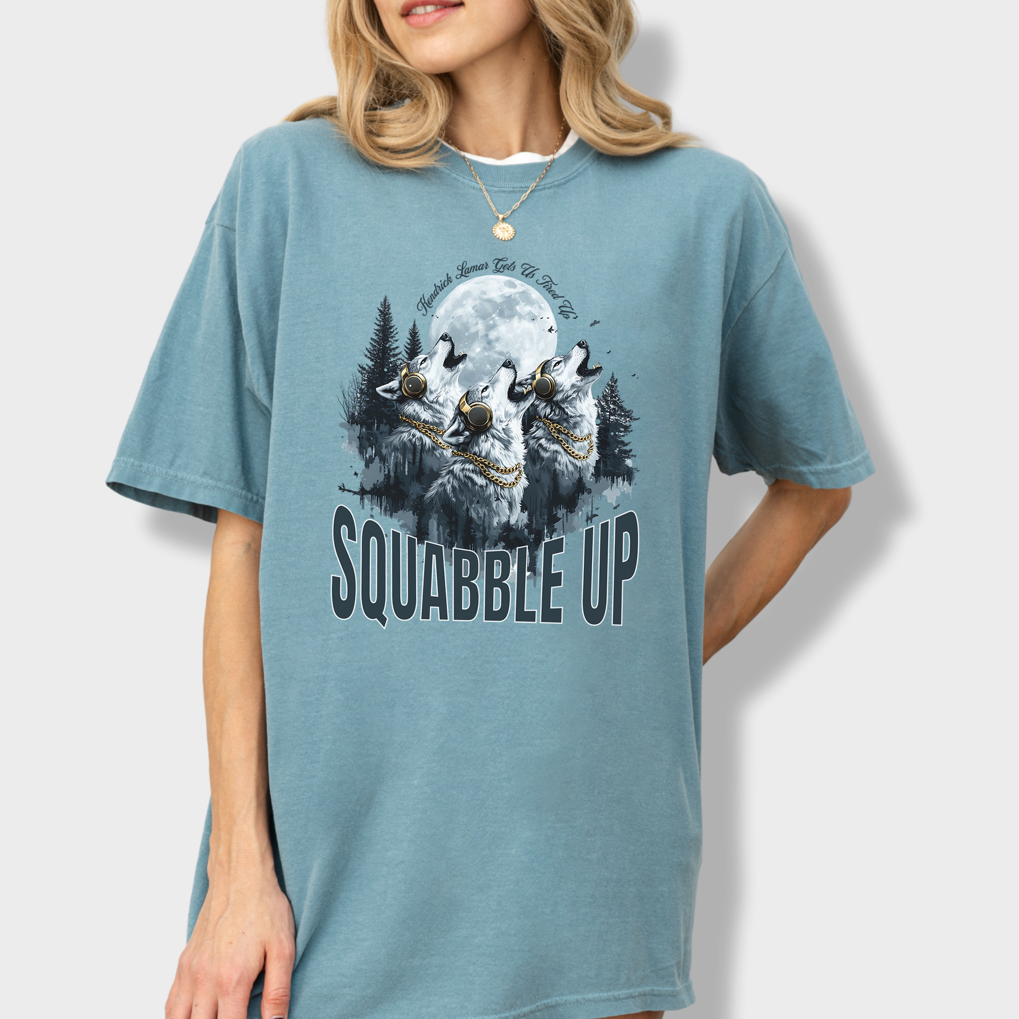 Bold wolf-themed T-shirt with 'Squabble Up' text, a howling pack wearing headphones, and a nod to Kendrick Lamar's fiery energy.