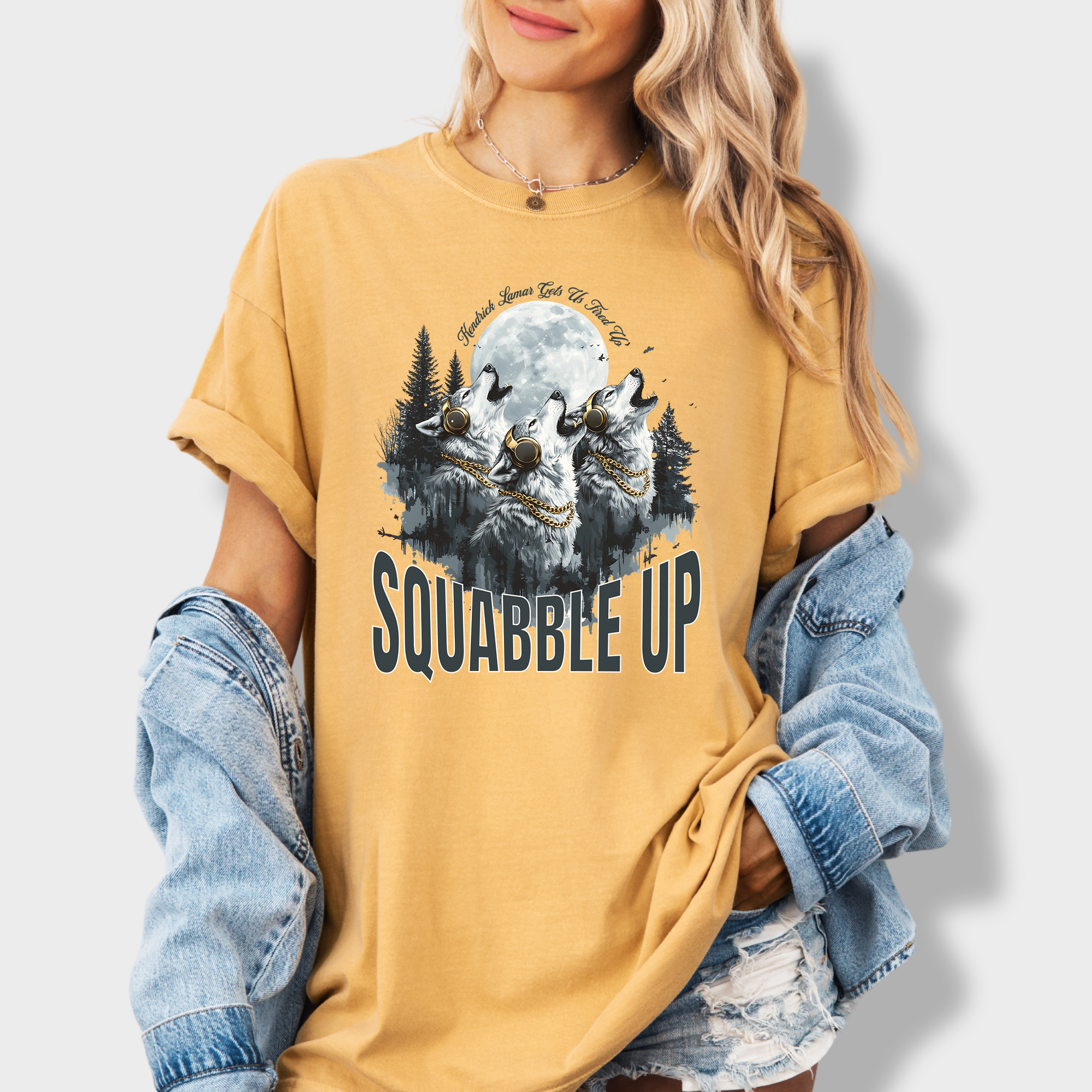 Retro-style wolf tee with a pack of howling wolves in headphones and bold 'Squabble Up' lettering, perfect for hip-hop and nature lovers.