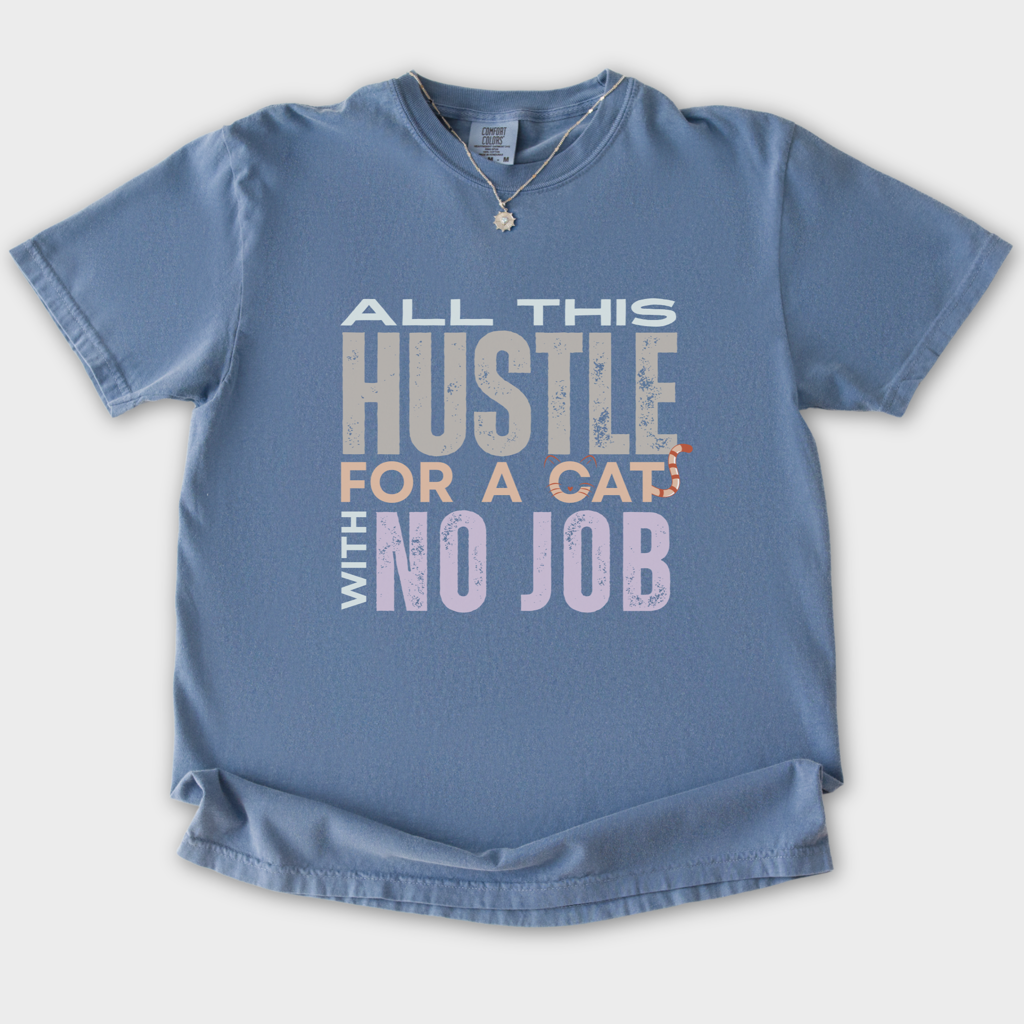 vintage-hustle-cat-with-no-job-cat-text-comfort-colors-t-shirt-in-blue-jean - Blue Jean Flat Lay Front