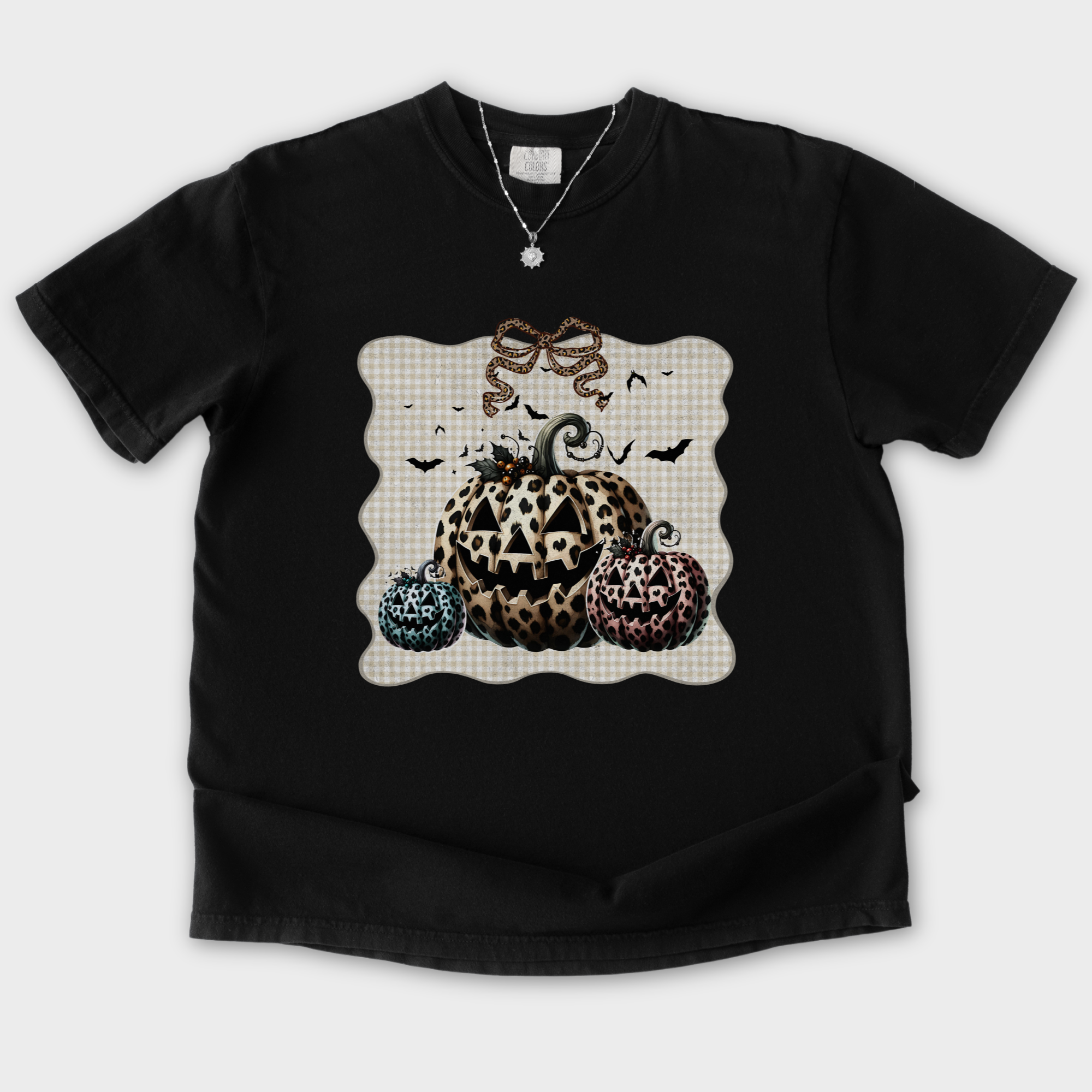 western-preppy-leopard-print-jack-o-lanterns-cat-bow-comfort-colors-t-shirt-in-black - Black Flat Lay Front