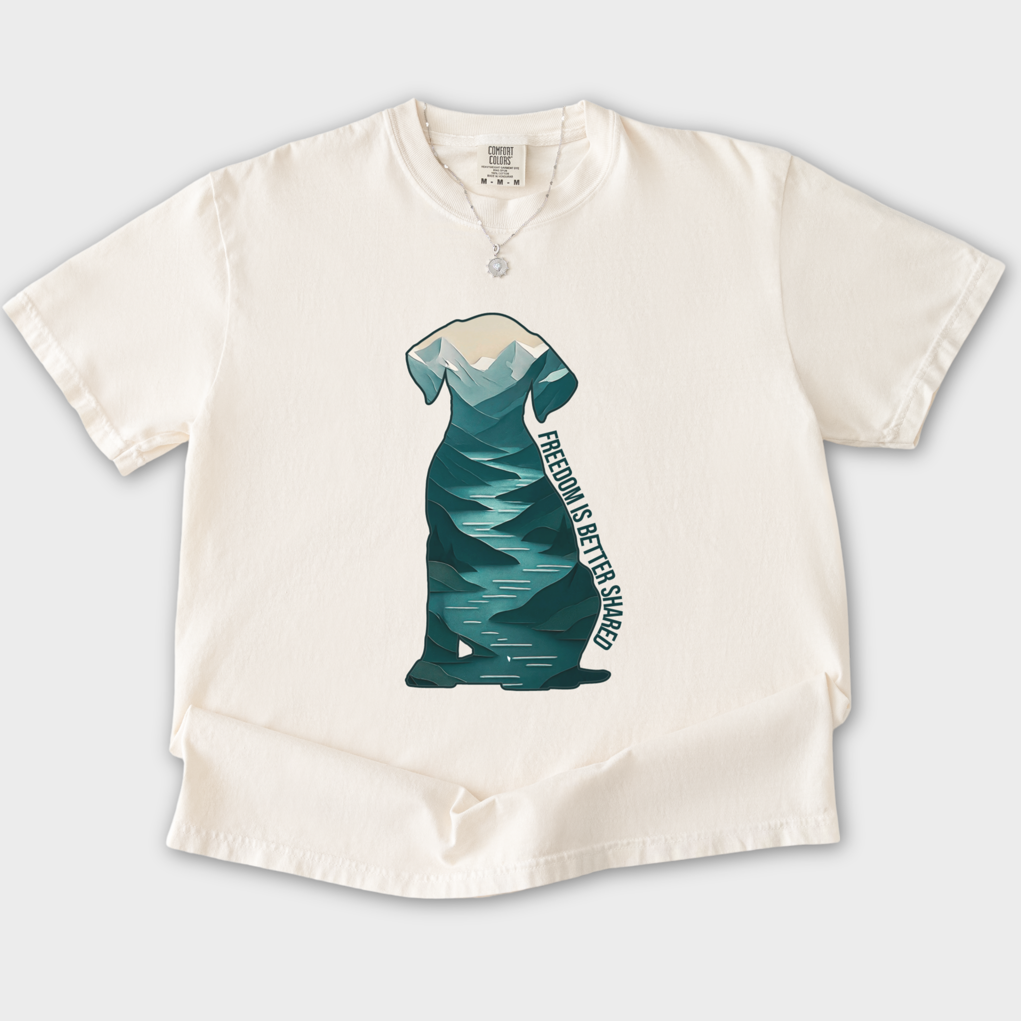 vintage-mountain-freedom-is-better-shared-dog-graphic-comfort-colors-t-shirt-in-ivory - Ivory Flat Lay Front