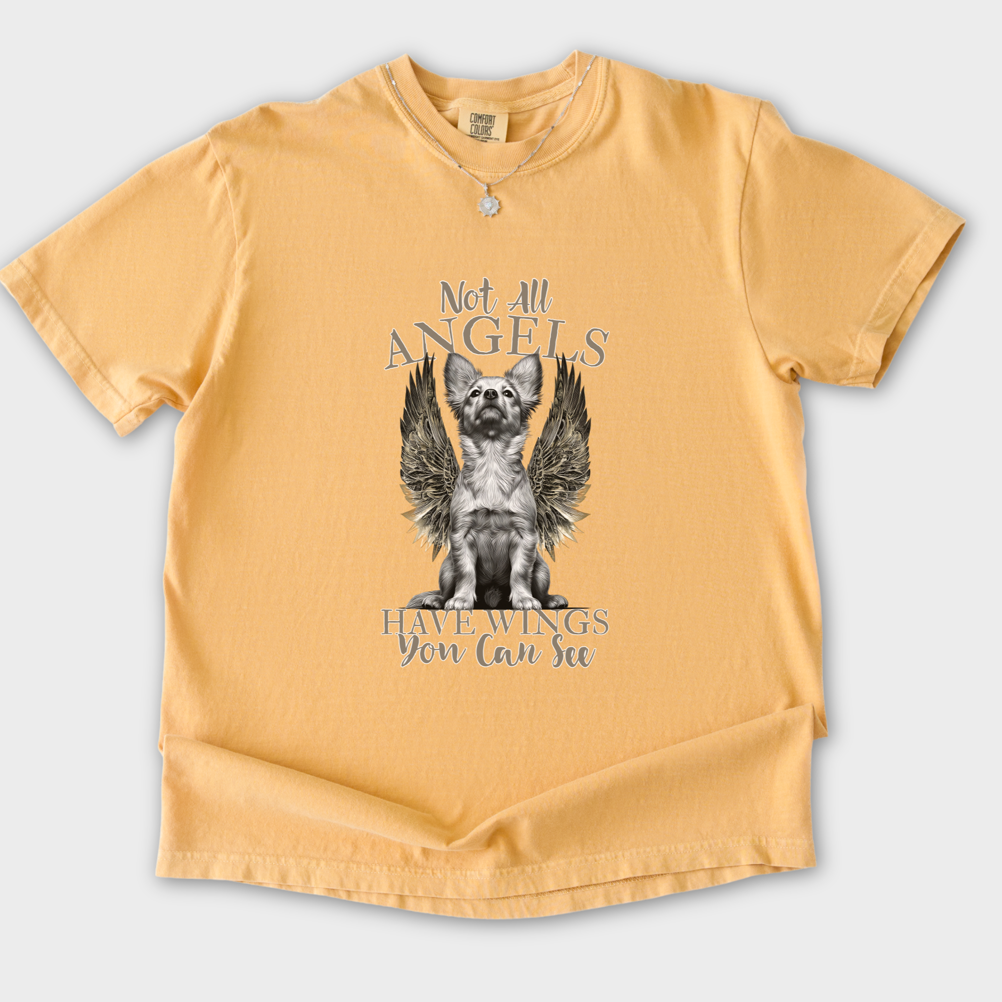 artistic-not-all-angels-have-wings-you-can-see-dog-graphic-comfort-colors-t-shirt-in-mustard - Mustard Flat Lay Front