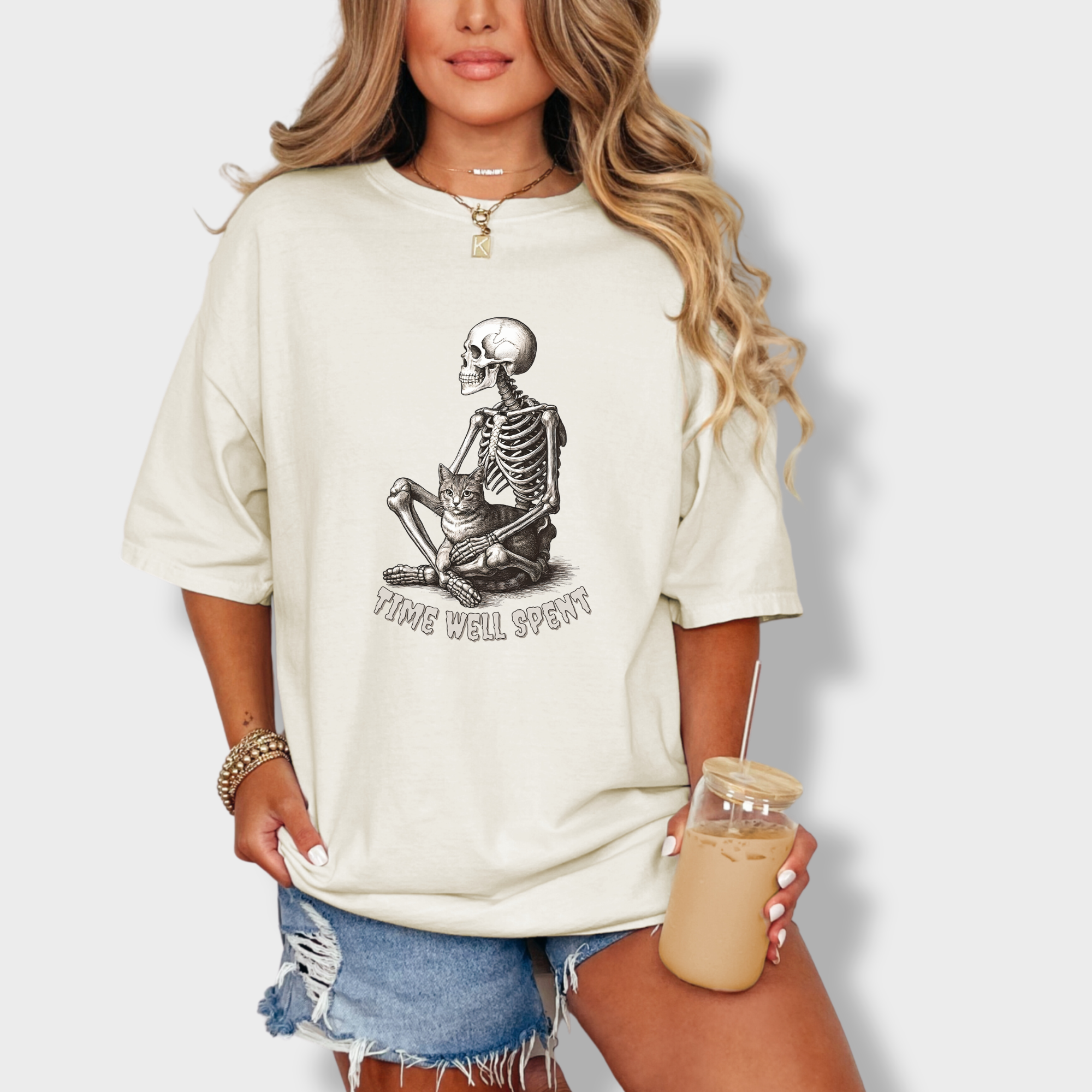 line-art-sit-still-skeleton-petting-cat-cat-skeleton-comfort-colors-t-shirt-in-ivory - Ivory Lifestyle Female Model
