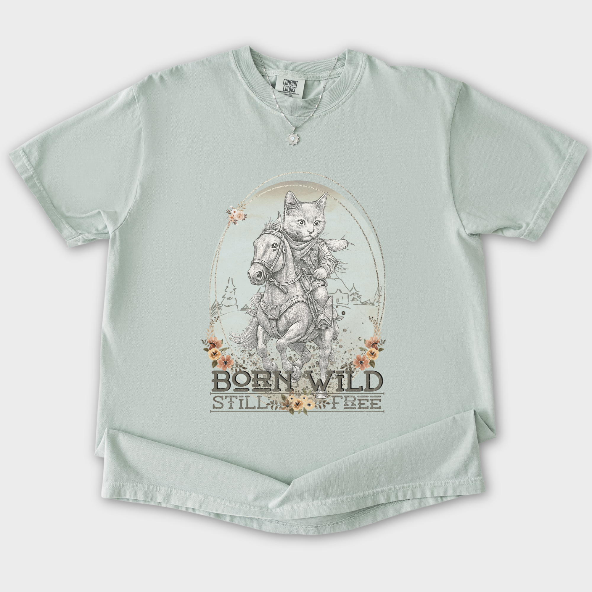 western-born-wild-still-free-gritty-kitty-cowboy-cat-line-art-comfort-colors-t-shirt-in-bay - Bay Flat Lay Front