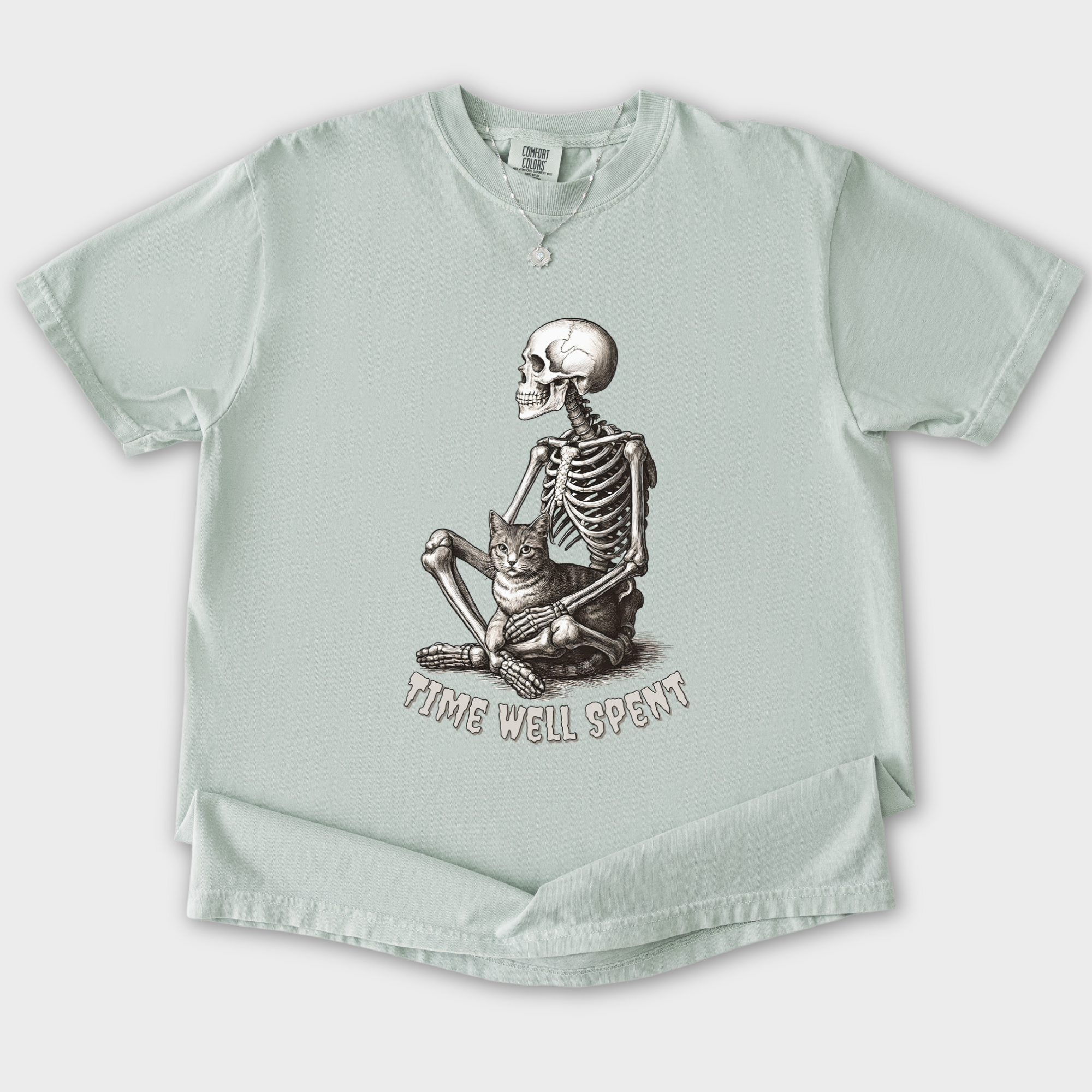 line-art-sit-still-skeleton-petting-cat-cat-skeleton-comfort-colors-t-shirt-in-granite - Granite Flat Lay Front