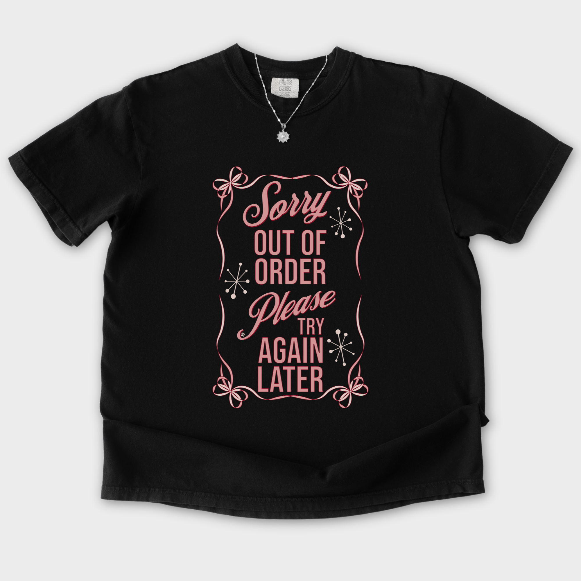 minimalist-sorry-out-of-order-please-try-again-later-feral-bow-comfort-colors-t-shirt-in-black - Black Flat Lay Front