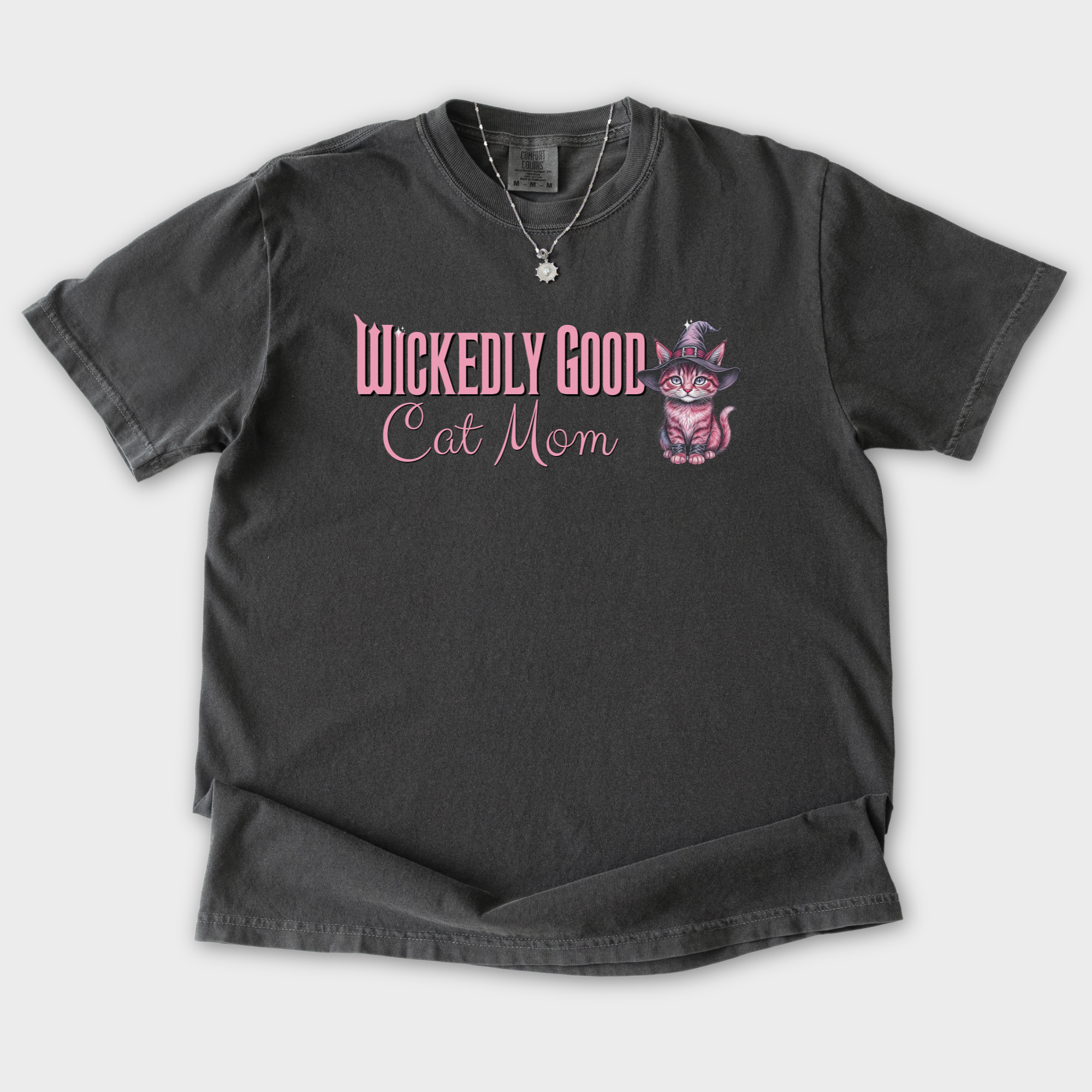 movie-inspired-pink-wickedly-good-cat-mom-cat-graphic-comfort-colors-t-shirt-in-pepper - Pepper Flat Lay Front