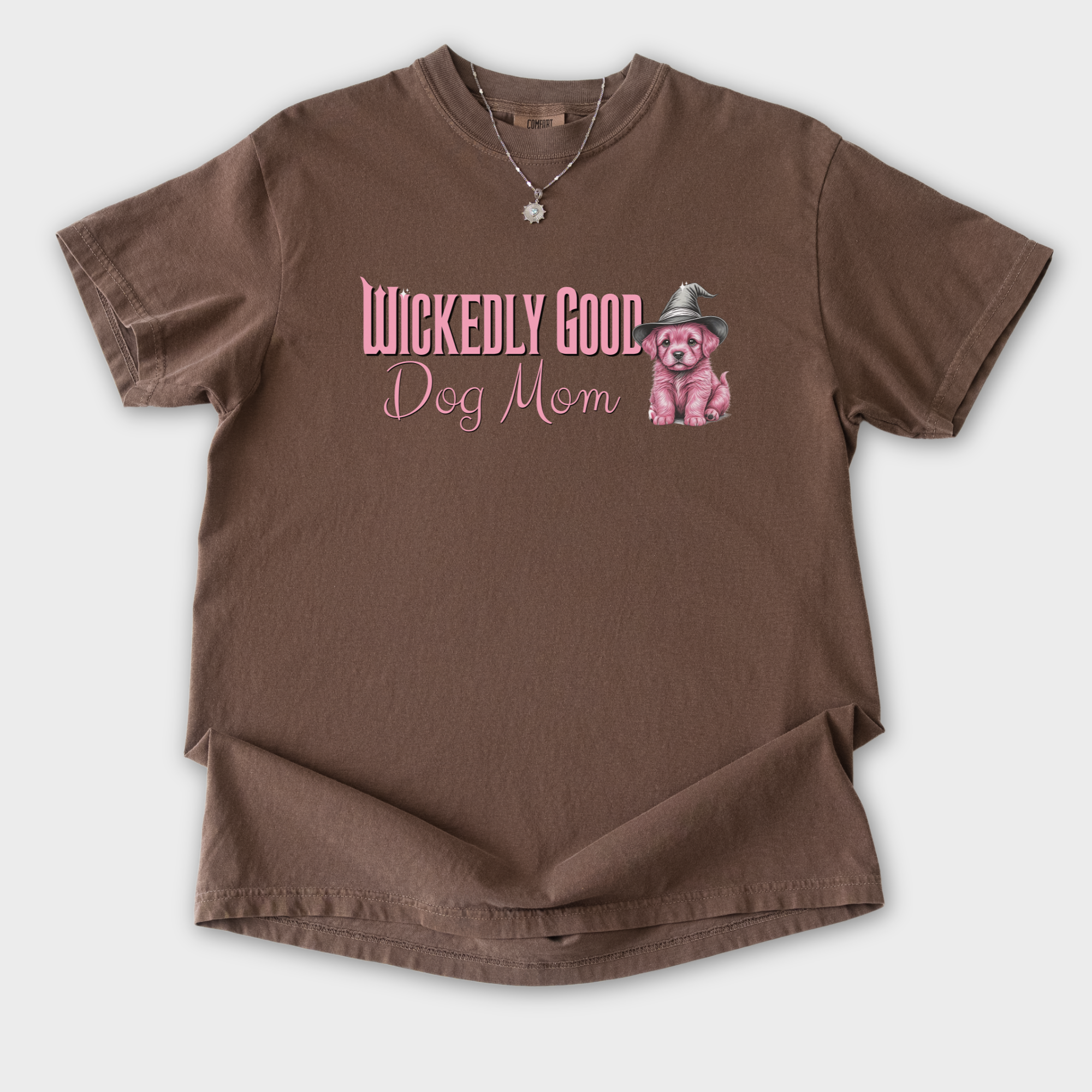 movie-inspired-pink-wickedly-good-dog-mom-dog-graphic-comfort-colors-t-shirt-in-espresso - Espresso Flat Lay Front