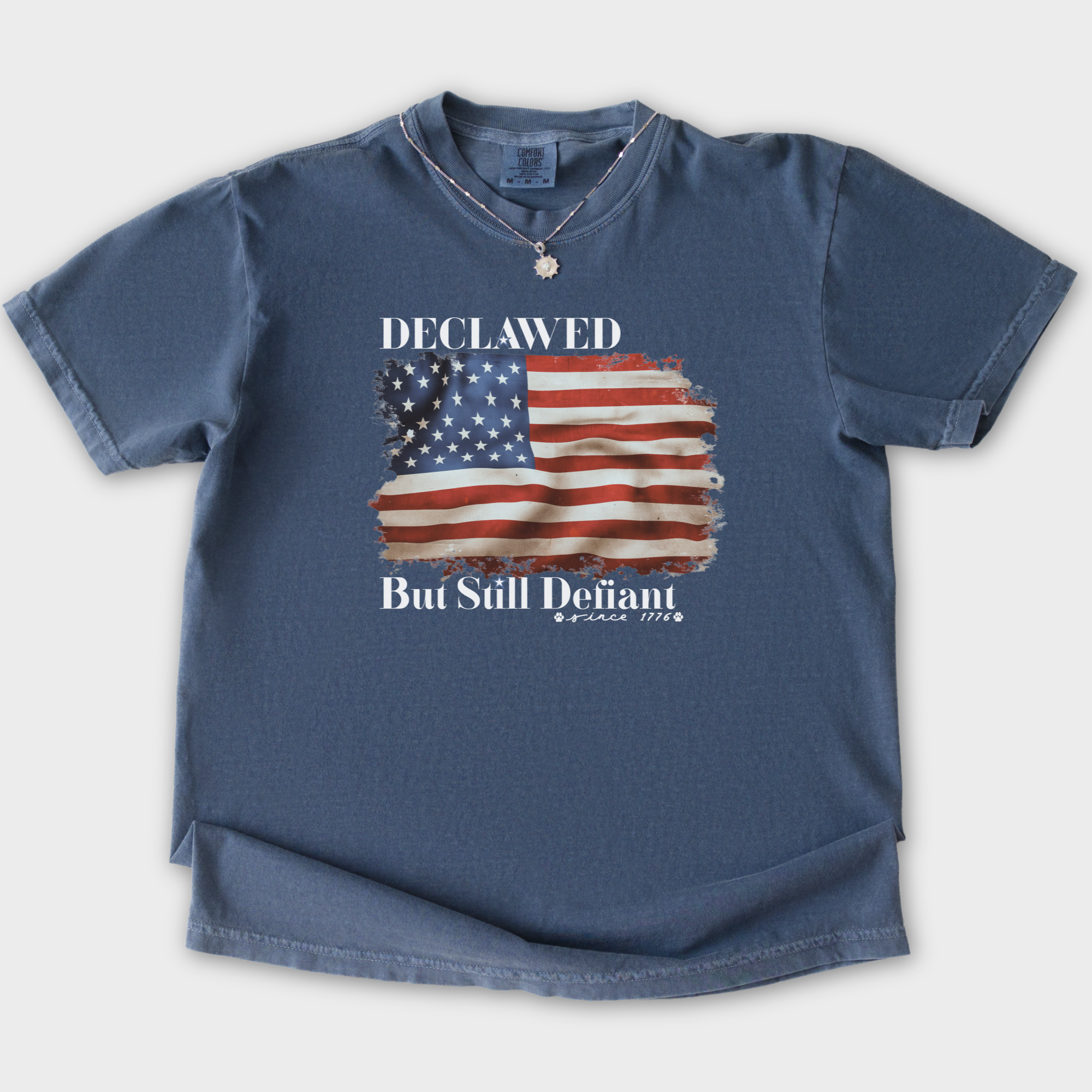 vintage-declawed-but-still-defiant-fourth-of-july-united-states-flag-cat-graphic-comfort-colors-t-shirt-in-denim - Denim Flat Lay Front