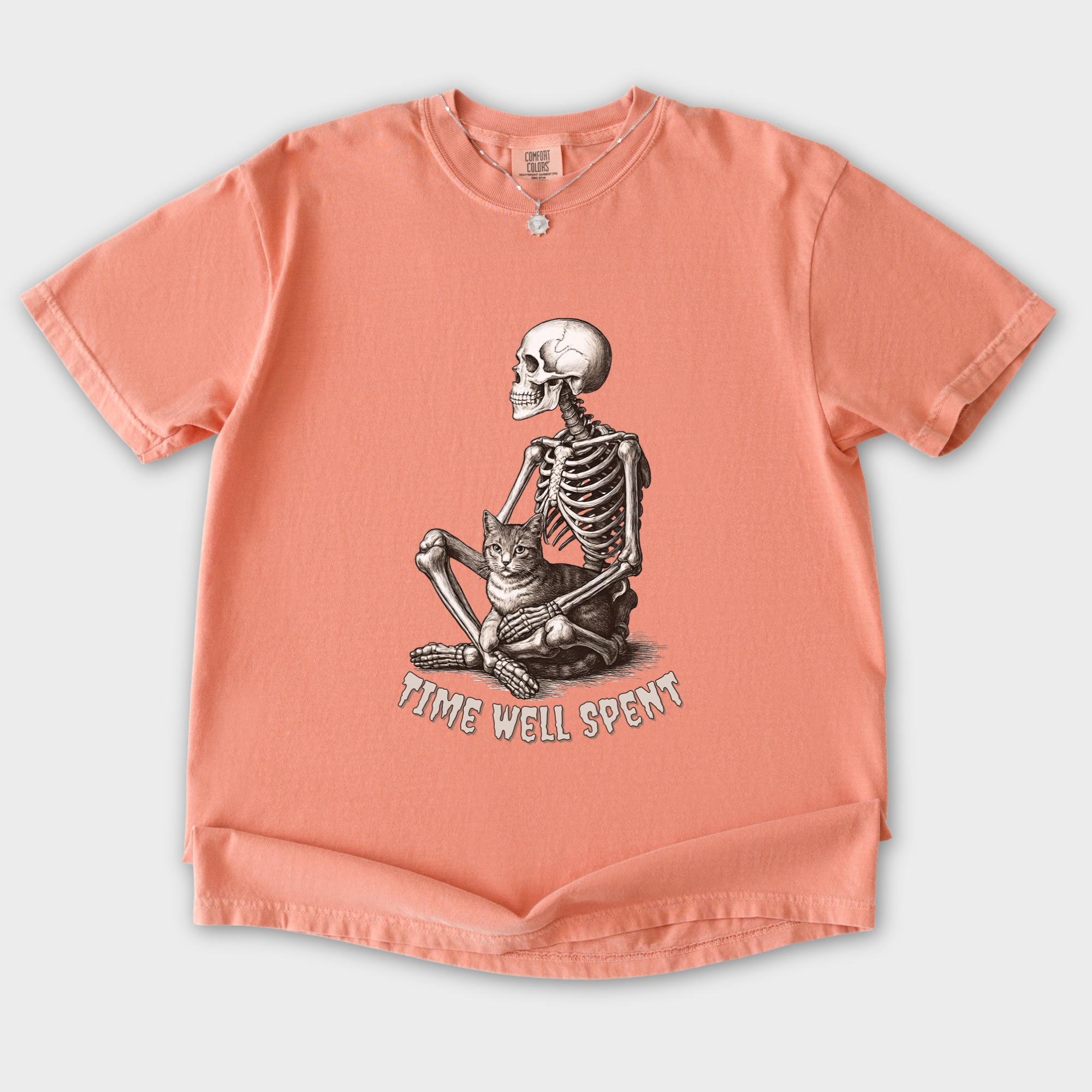 line-art-sit-still-skeleton-petting-cat-cat-skeleton-comfort-colors-t-shirt-in-terracotta - Terracotta Flat Lay Front