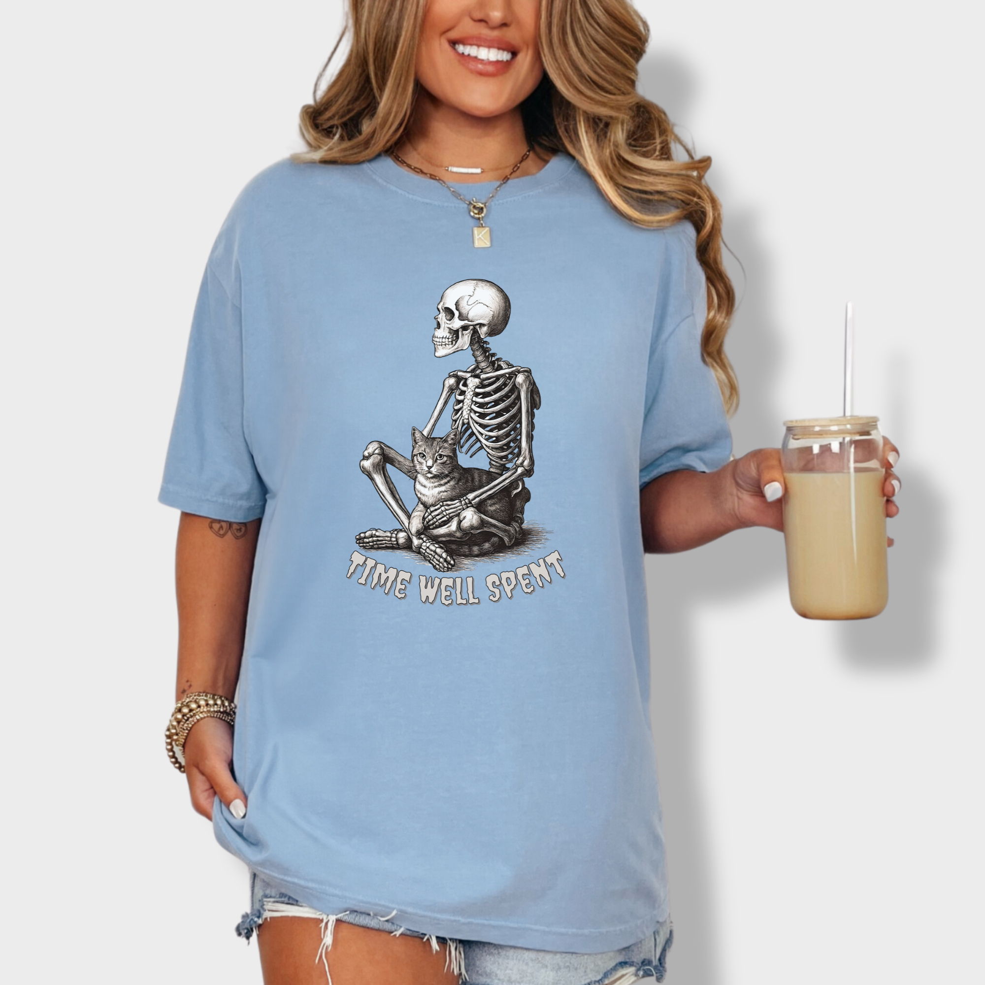 line-art-sit-still-skeleton-petting-cat-cat-skeleton-comfort-colors-t-shirt-in-washed-denim - Washed Denim Lifestyle Female Model