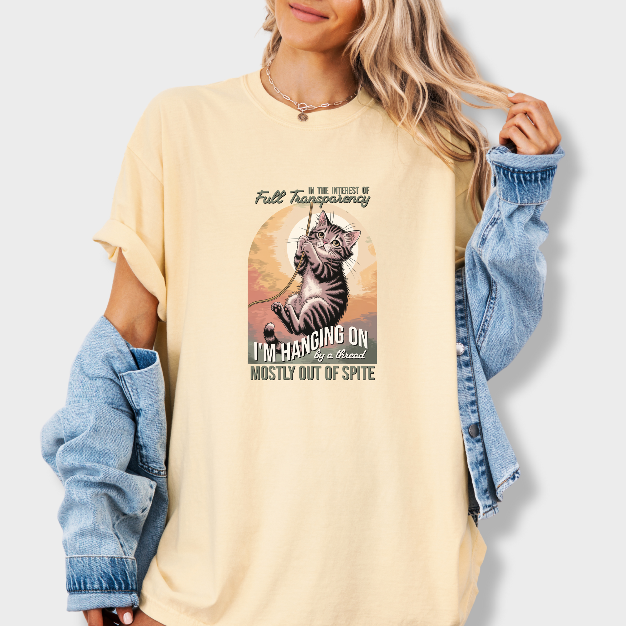 western-hanging-on-by-a-thread-cat-graphic-comfort-colors-t-shirt-in-butter - Butter Lifestyle Female Model