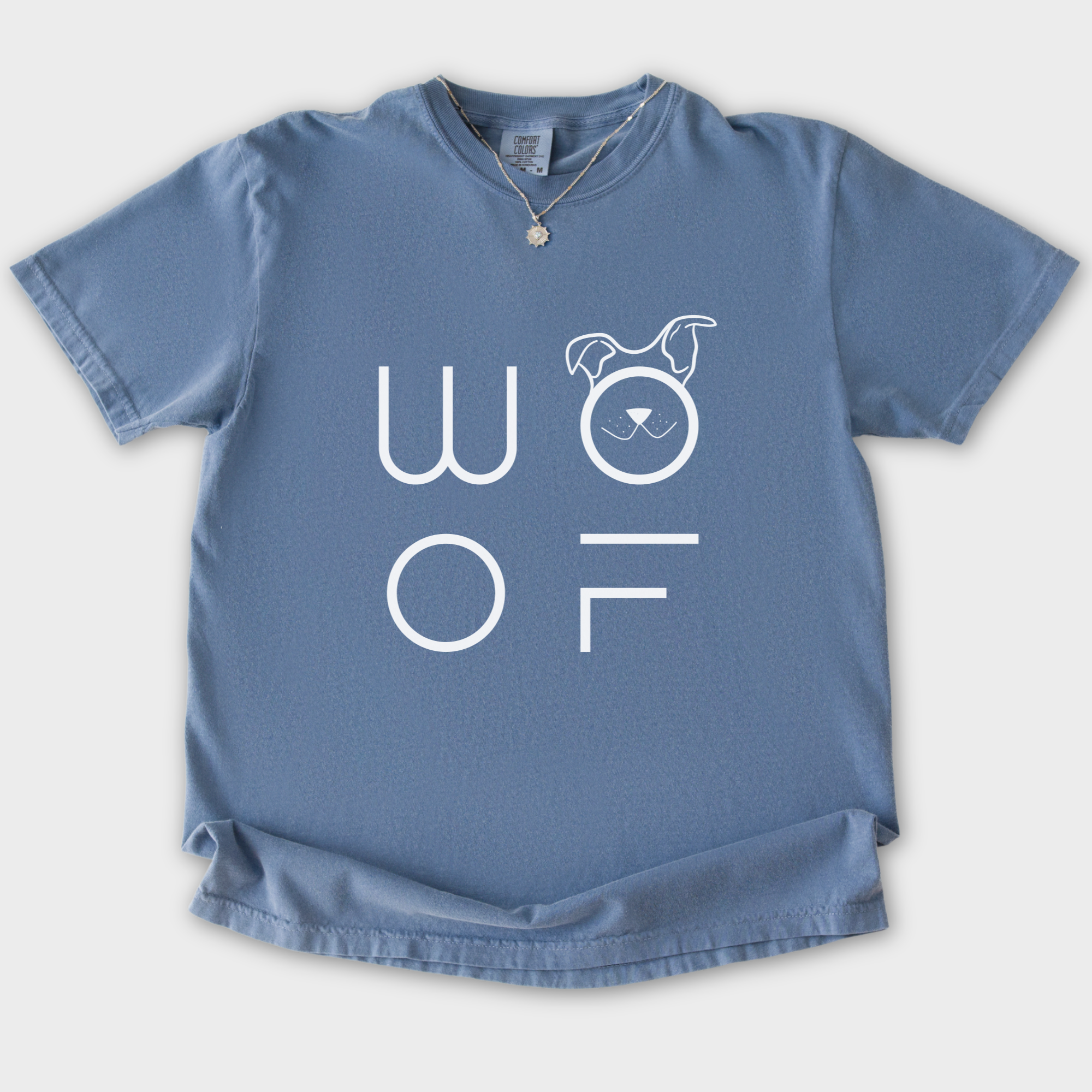 minimalist-woof-modern-text-design-dog-text-comfort-colors-t-shirt-in-blue-jean - Blue Jean Flat Lay Front
