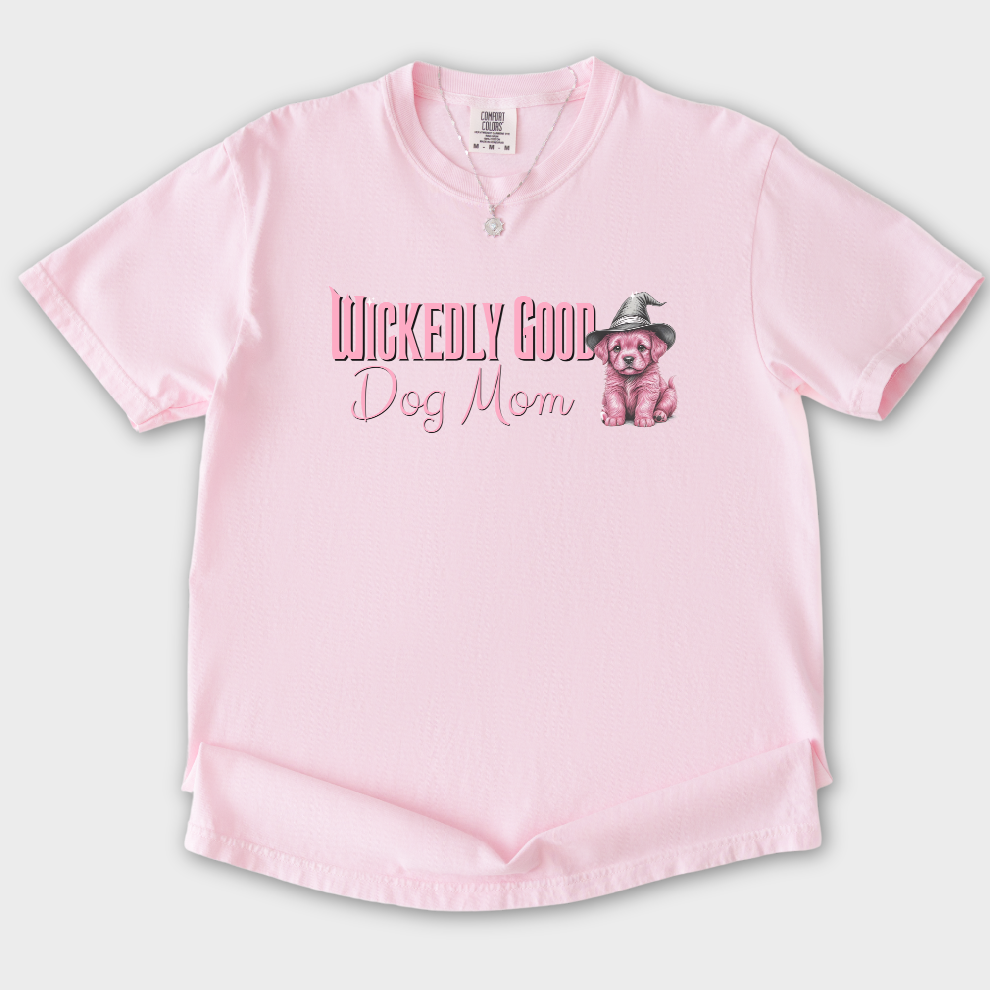 movie-inspired-pink-wickedly-good-dog-mom-dog-graphic-comfort-colors-t-shirt-in-blossom - Blossom Flat Lay Front