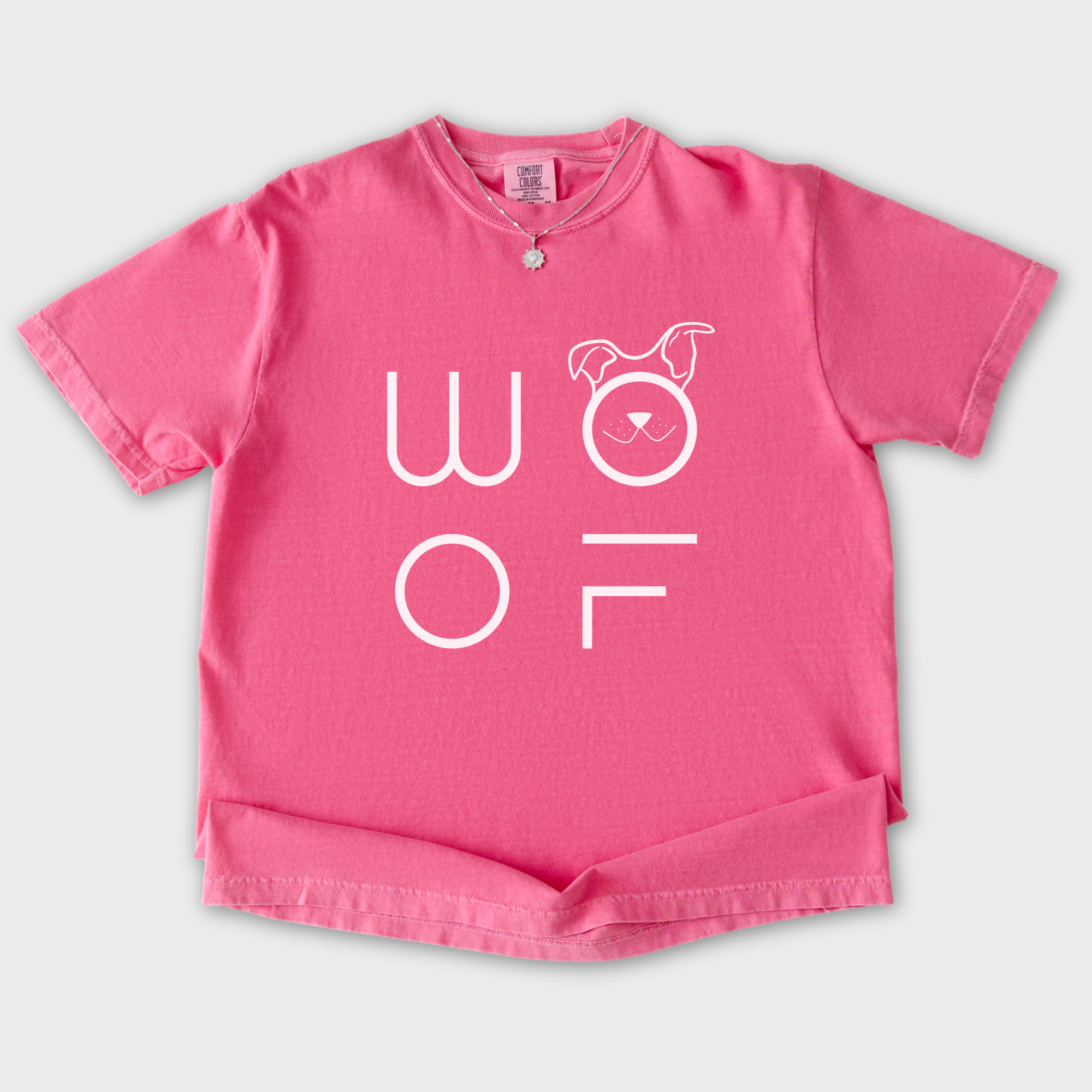 minimalist-woof-modern-text-design-dog-text-comfort-colors-t-shirt-in-crunchberry - Crunchberry Flat Lay Front