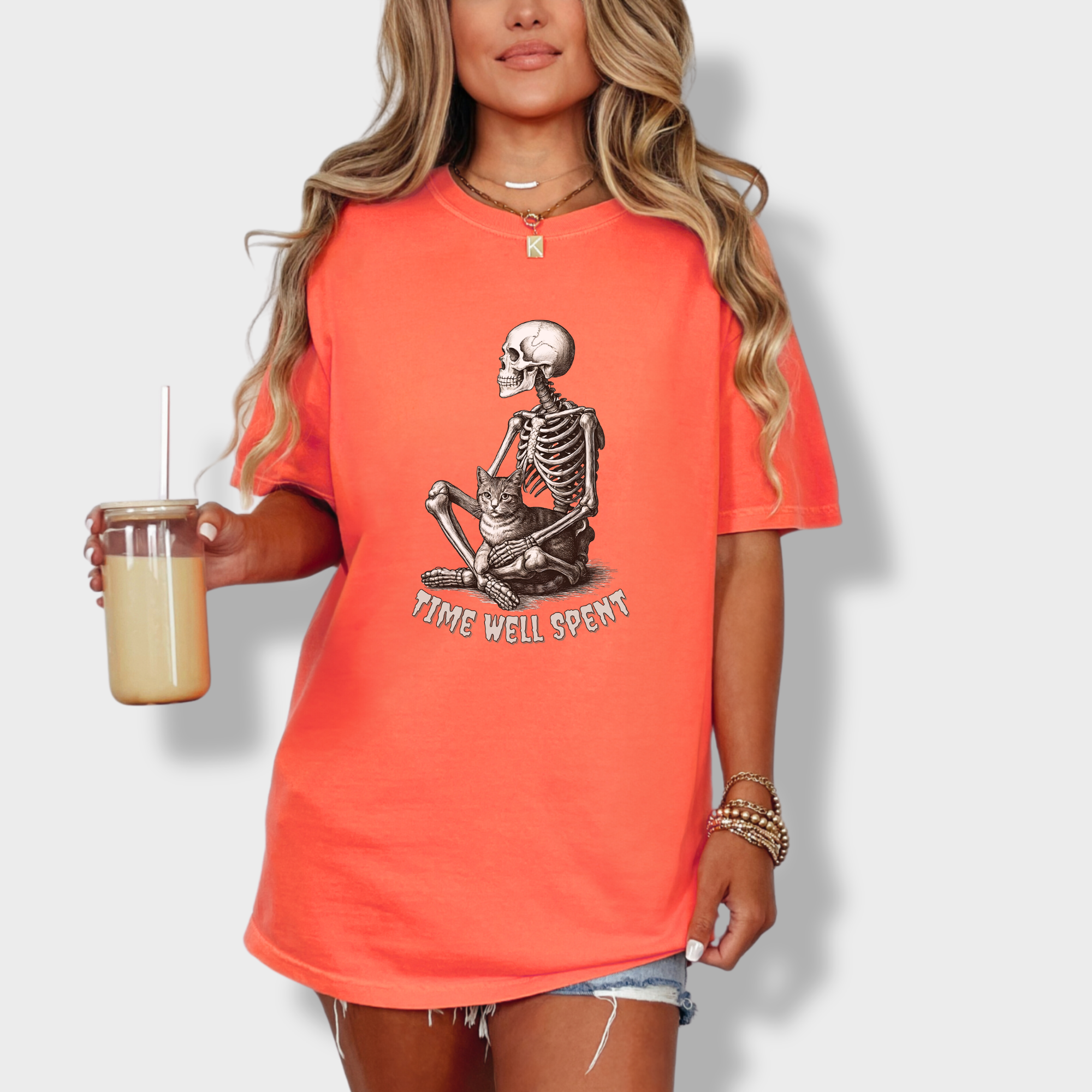 line-art-sit-still-skeleton-petting-cat-cat-skeleton-comfort-colors-t-shirt-in-bright-salmon - Bright Salmon Lifestyle Female Model
